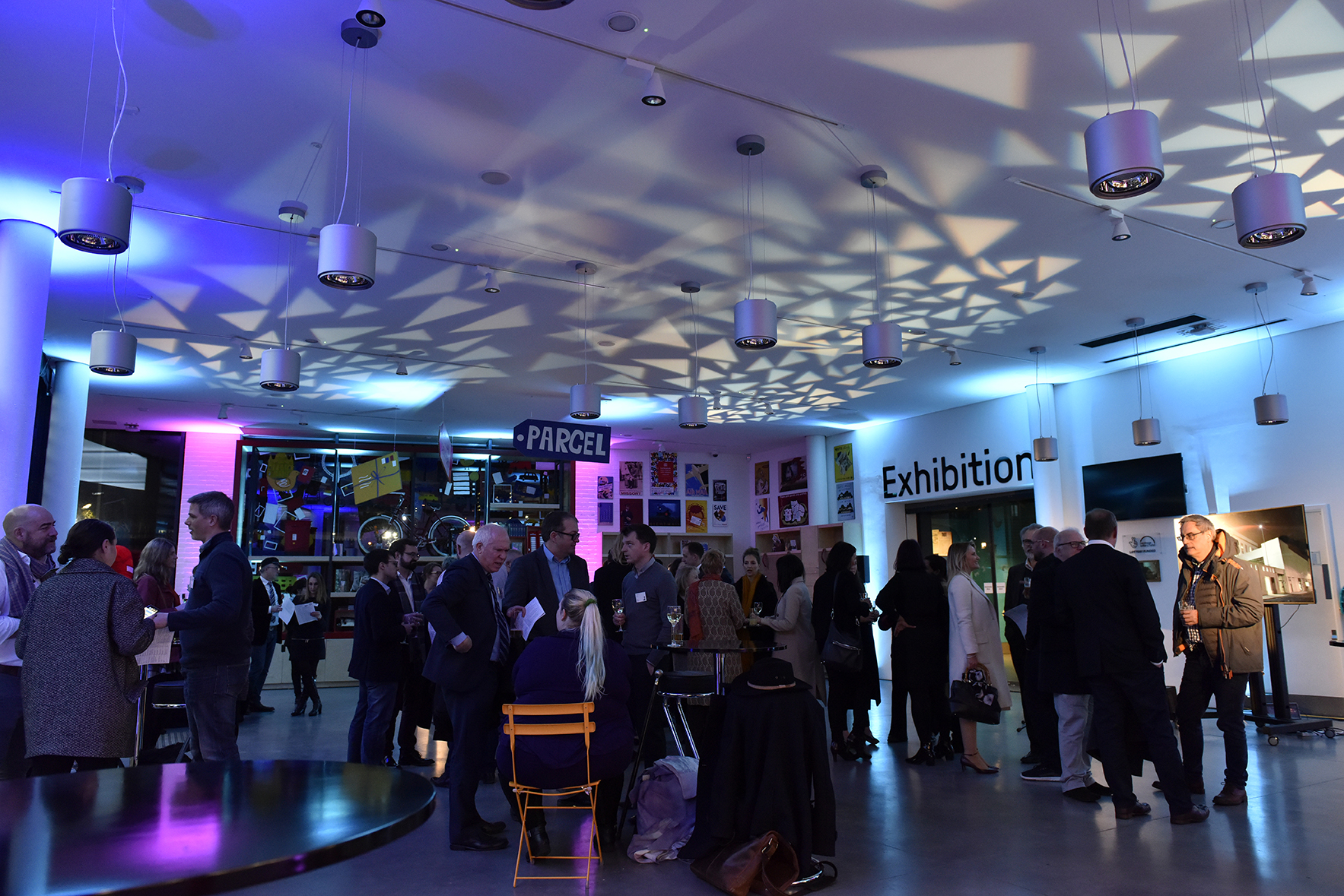 Vibrant networking event in The Postal Museum's Courtyard with dynamic lighting.
