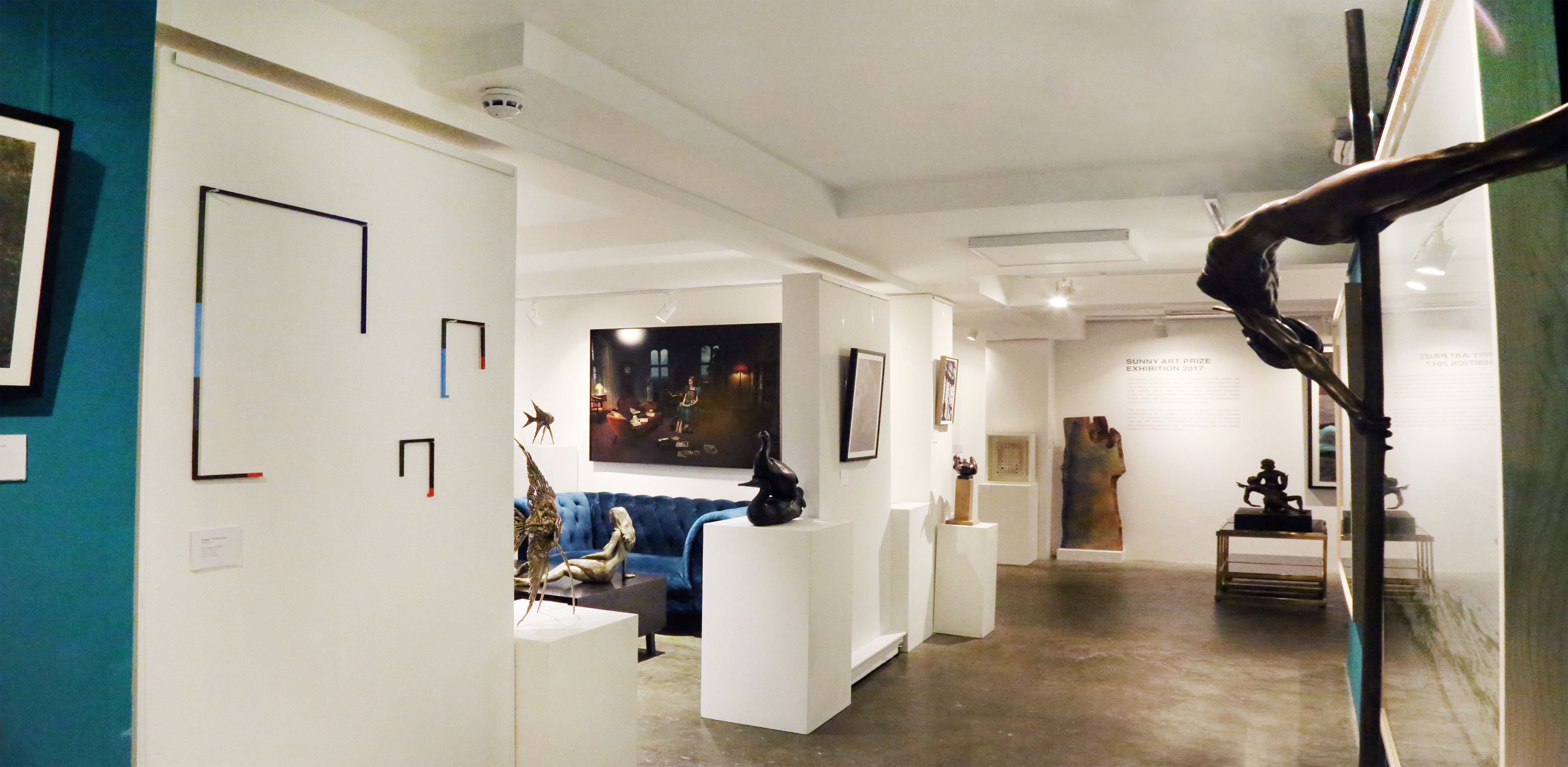 Modern art gallery space with sculptures, perfect for intimate events and exhibitions.