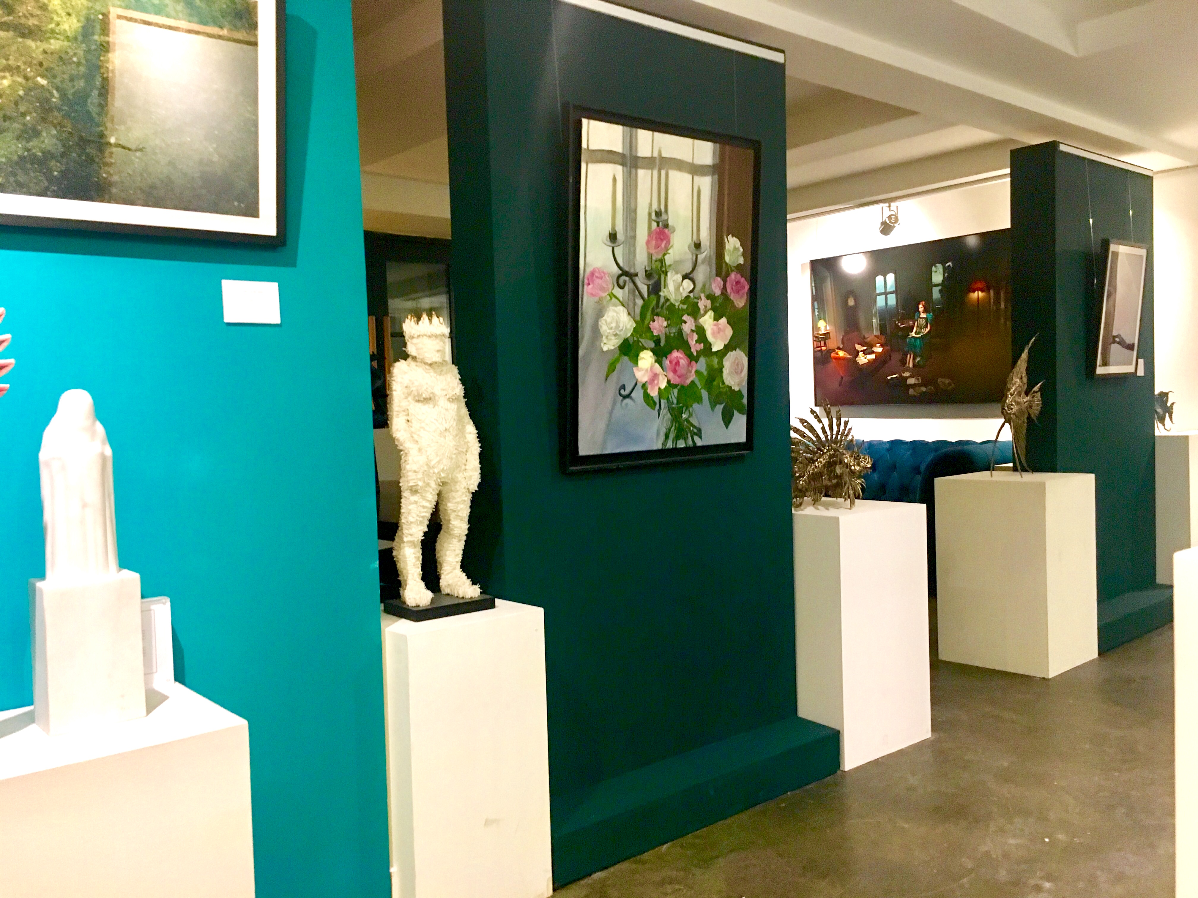 Stylish gallery space with teal walls, perfect for art exhibitions and corporate events.