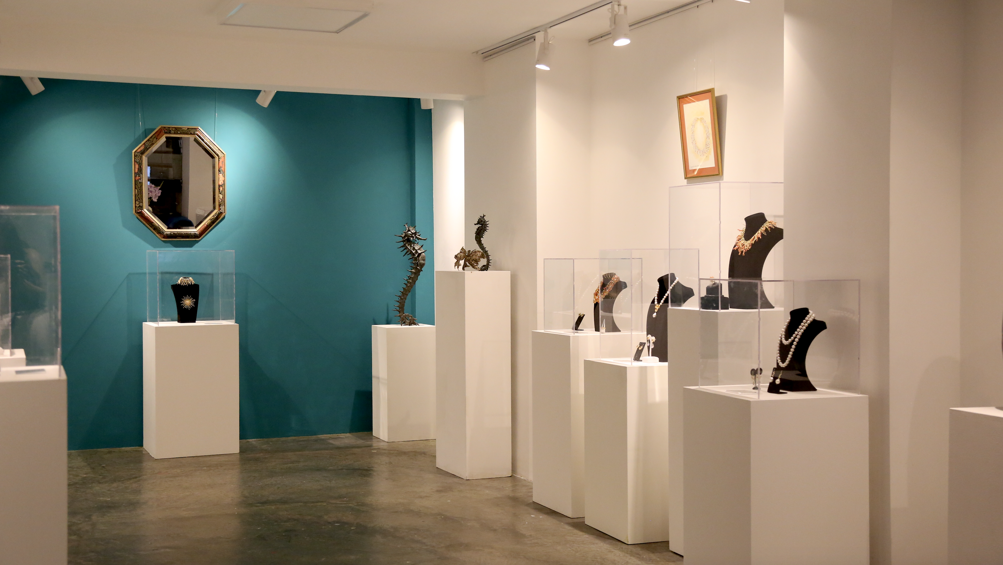 Modern exhibition space at Sunny Art Centre showcasing elegant jewelry and art.