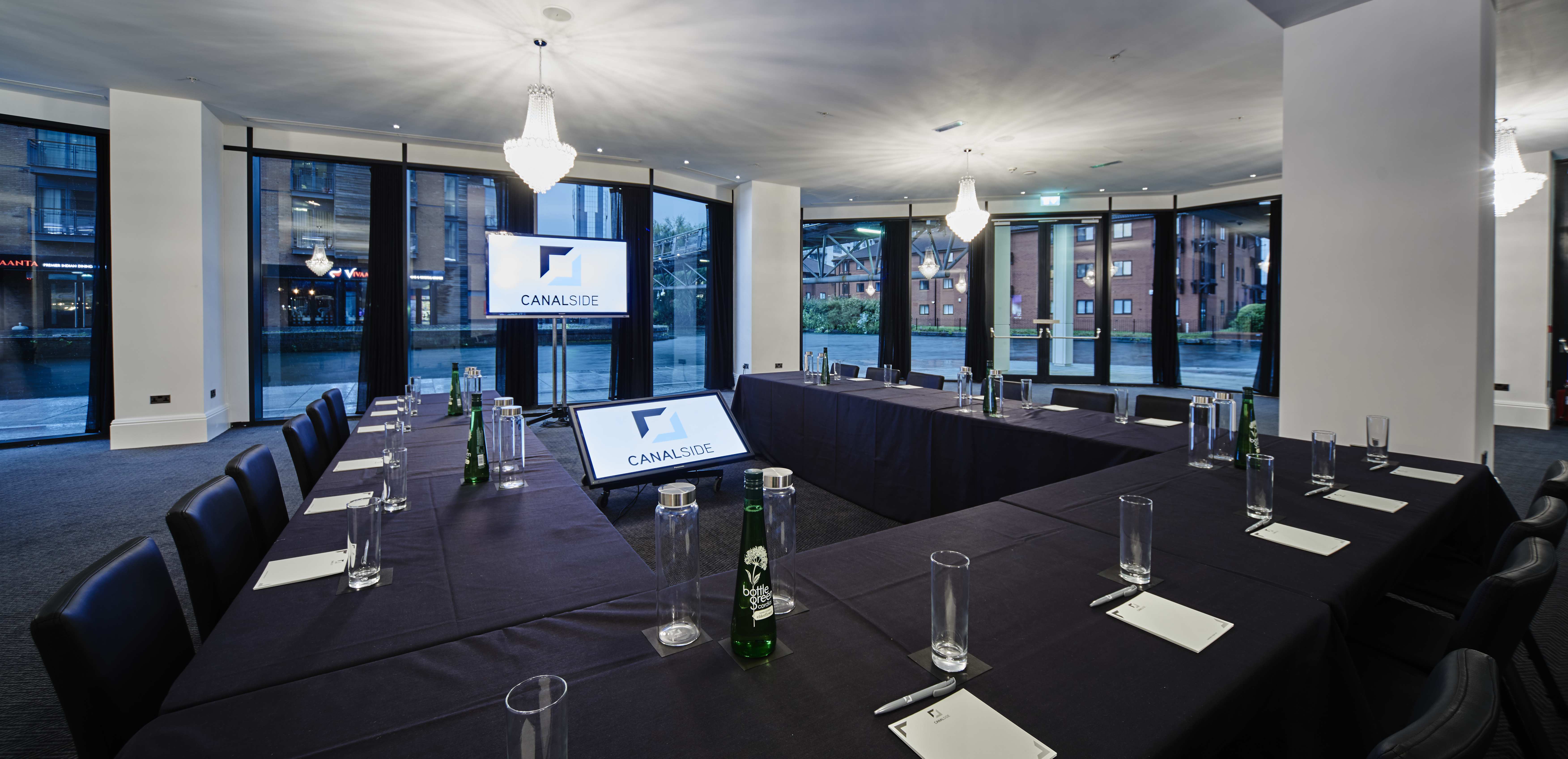 Corporate meeting room with U-shaped table setup for events at Canalside.