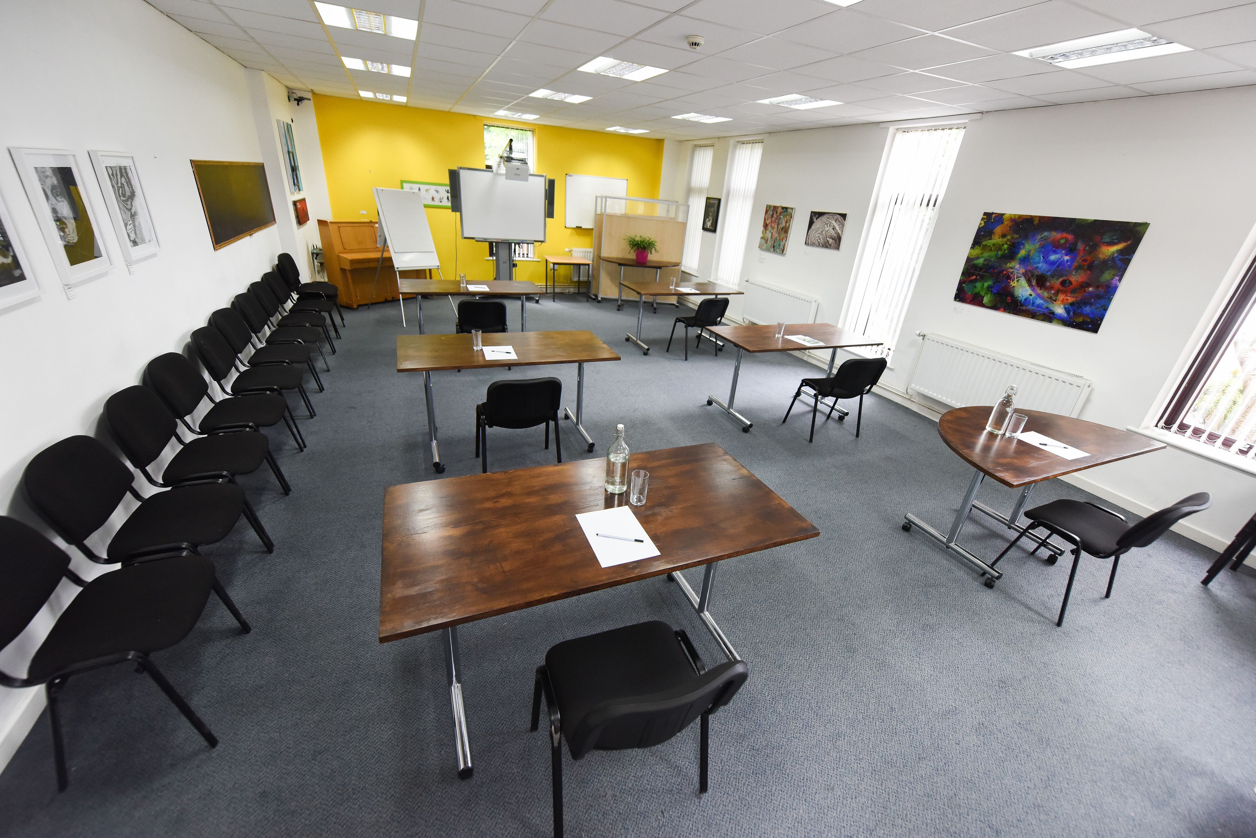 Meeting Room at The Brain Charity with yellow wall, ideal for collaborative events.