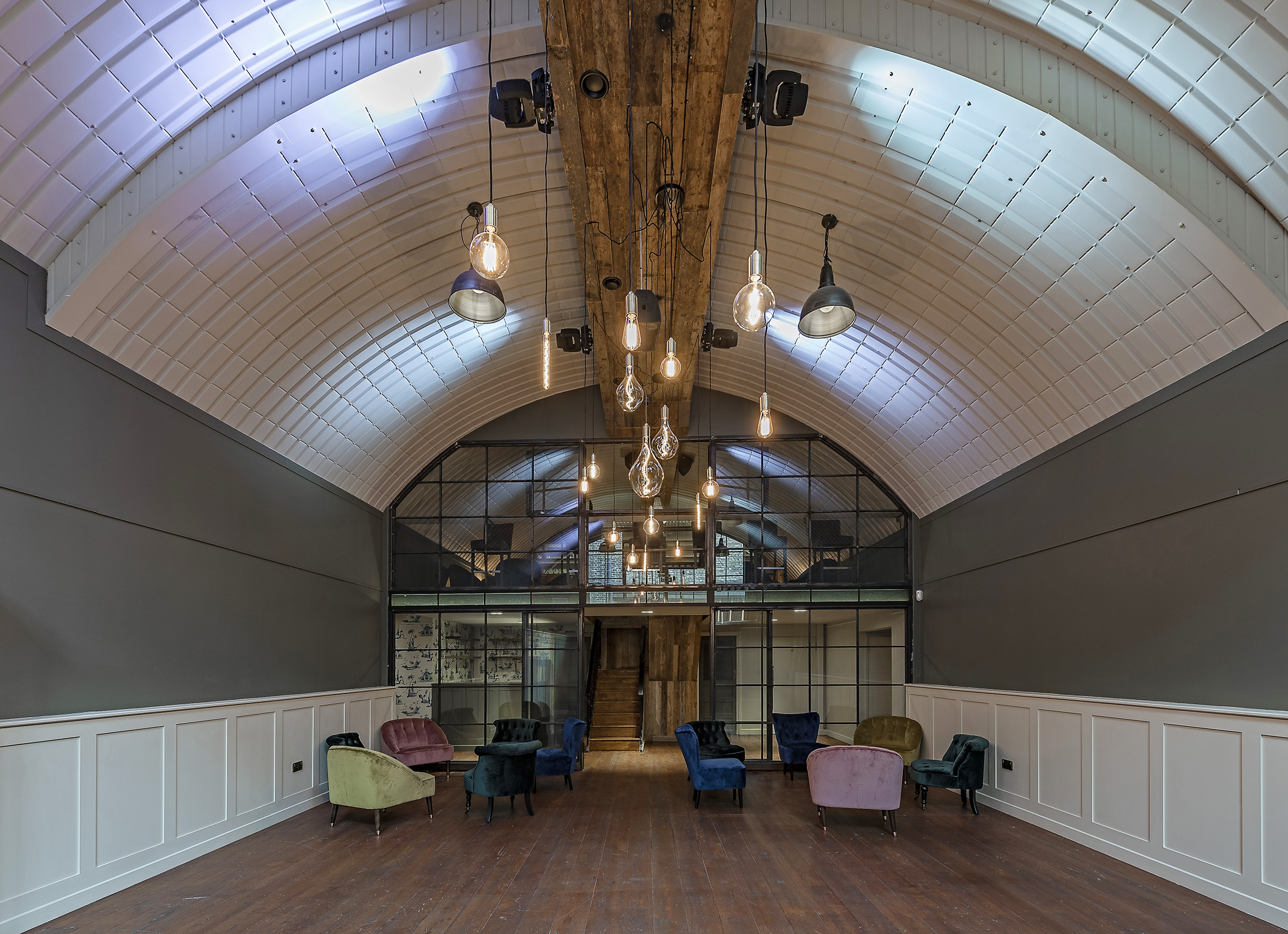 Versatile event space with arched ceiling, ideal for gatherings and meetings in Rae's.