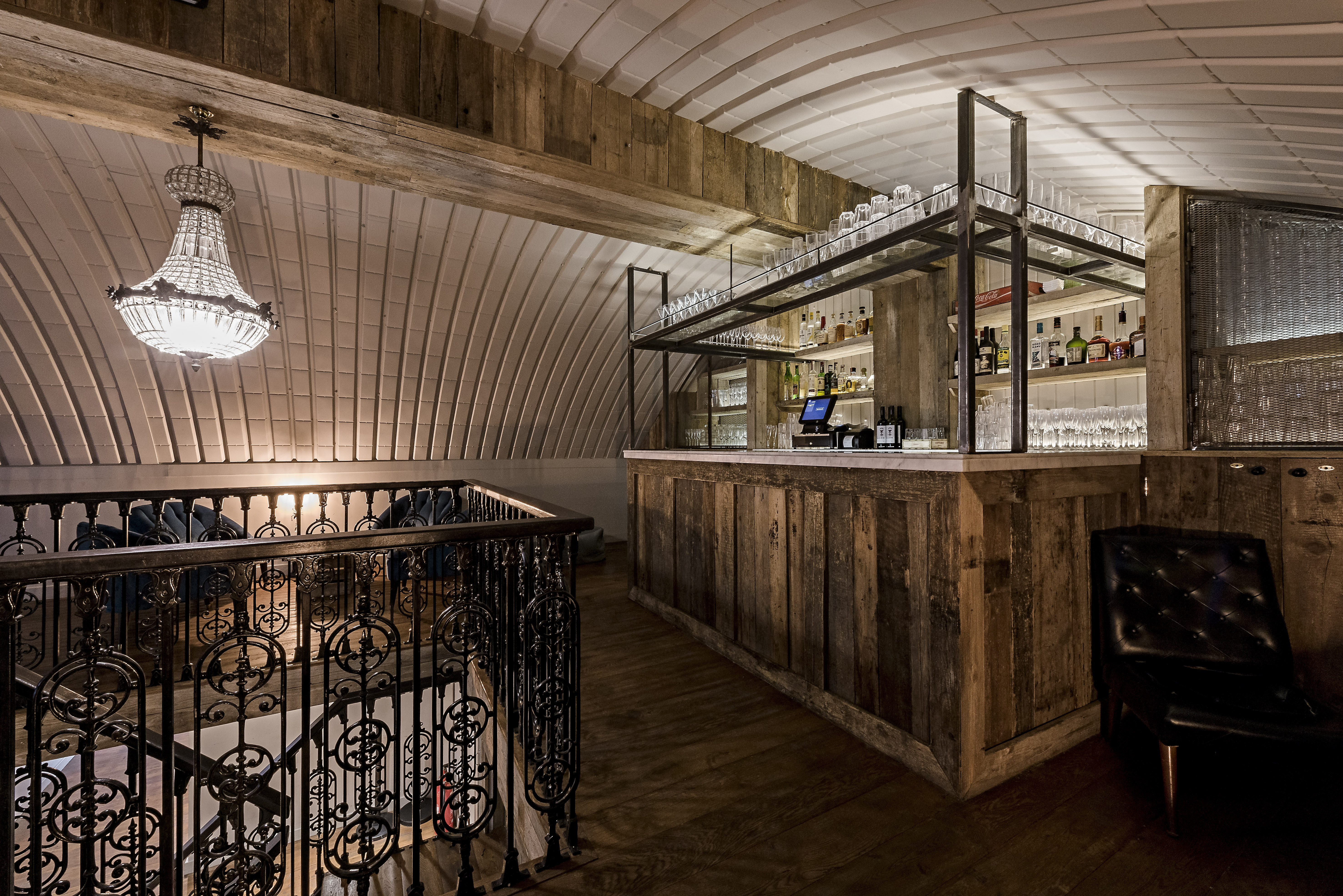 Sophisticated bar area with chandelier in Rae's Venue for upscale events and gatherings.