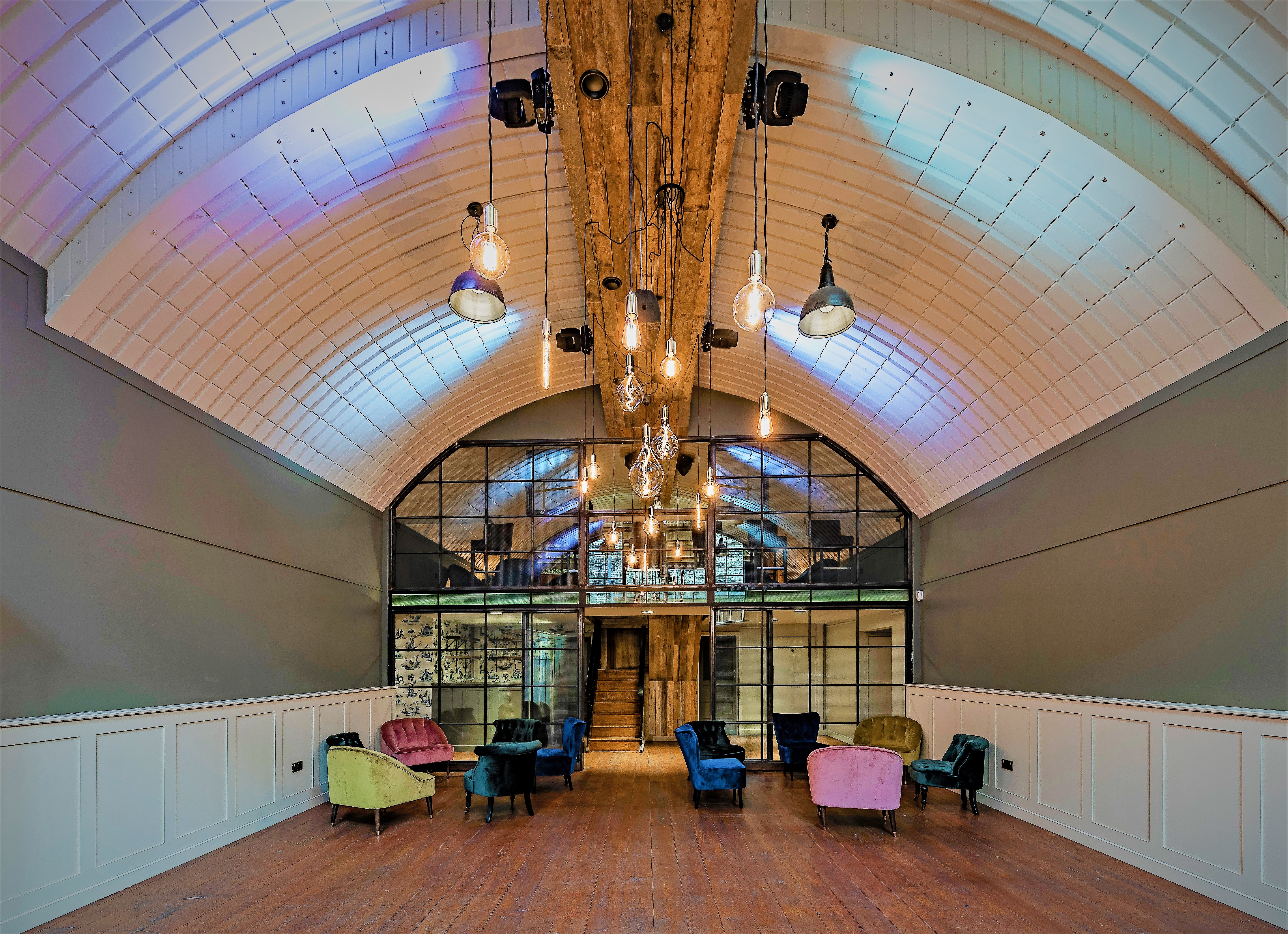 Versatile event space with vaulted ceilings, ideal for corporate and social gatherings.