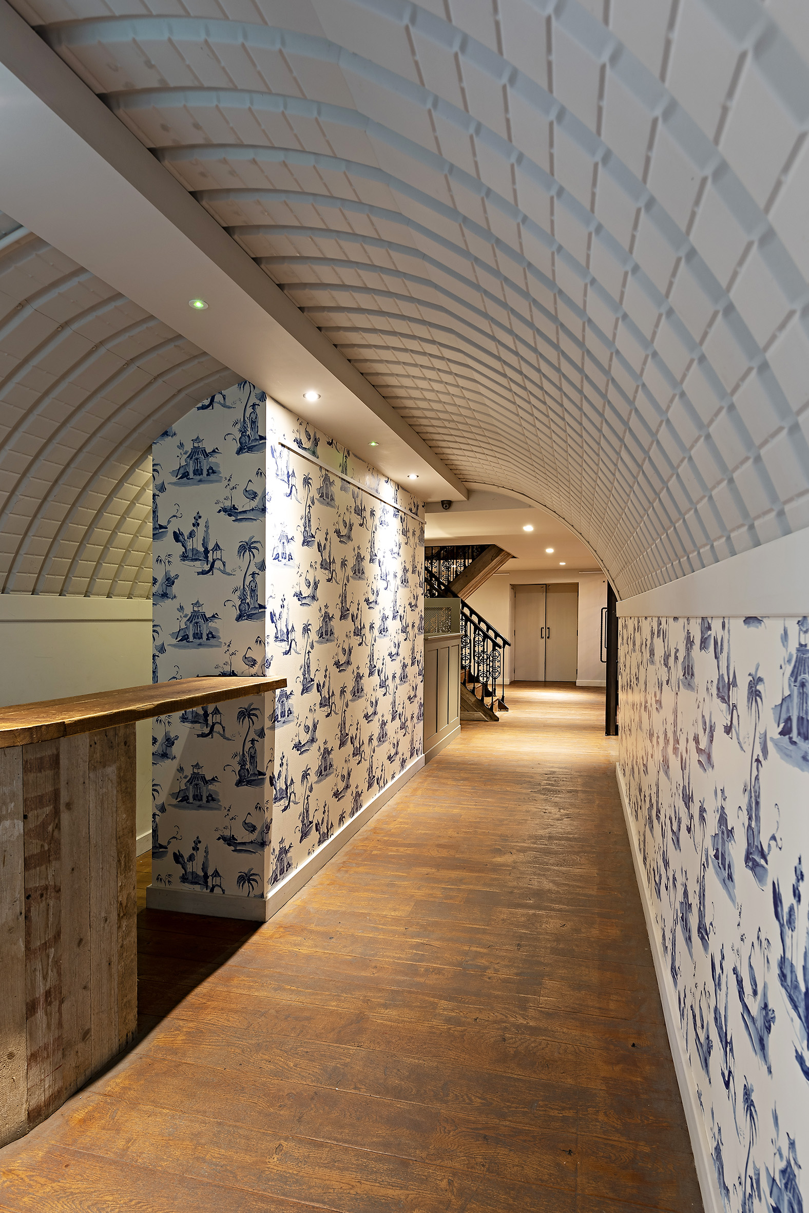 Stylish event corridor at Rae's with decorative wallpaper and inviting atmosphere.