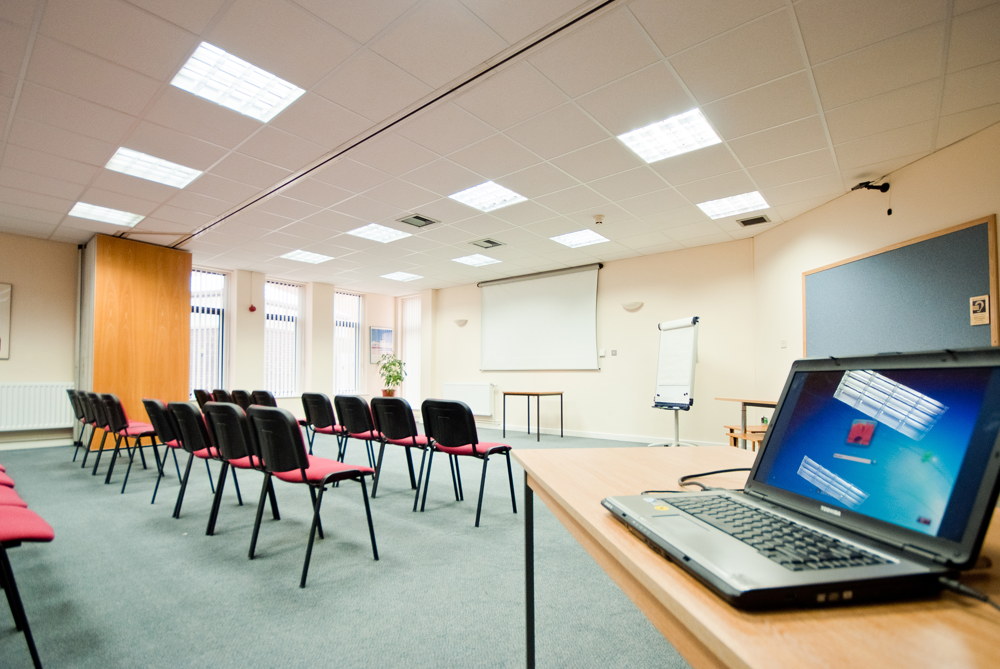 Bright seminar room with chairs and tech setup for engaging events at The Brain Charity.