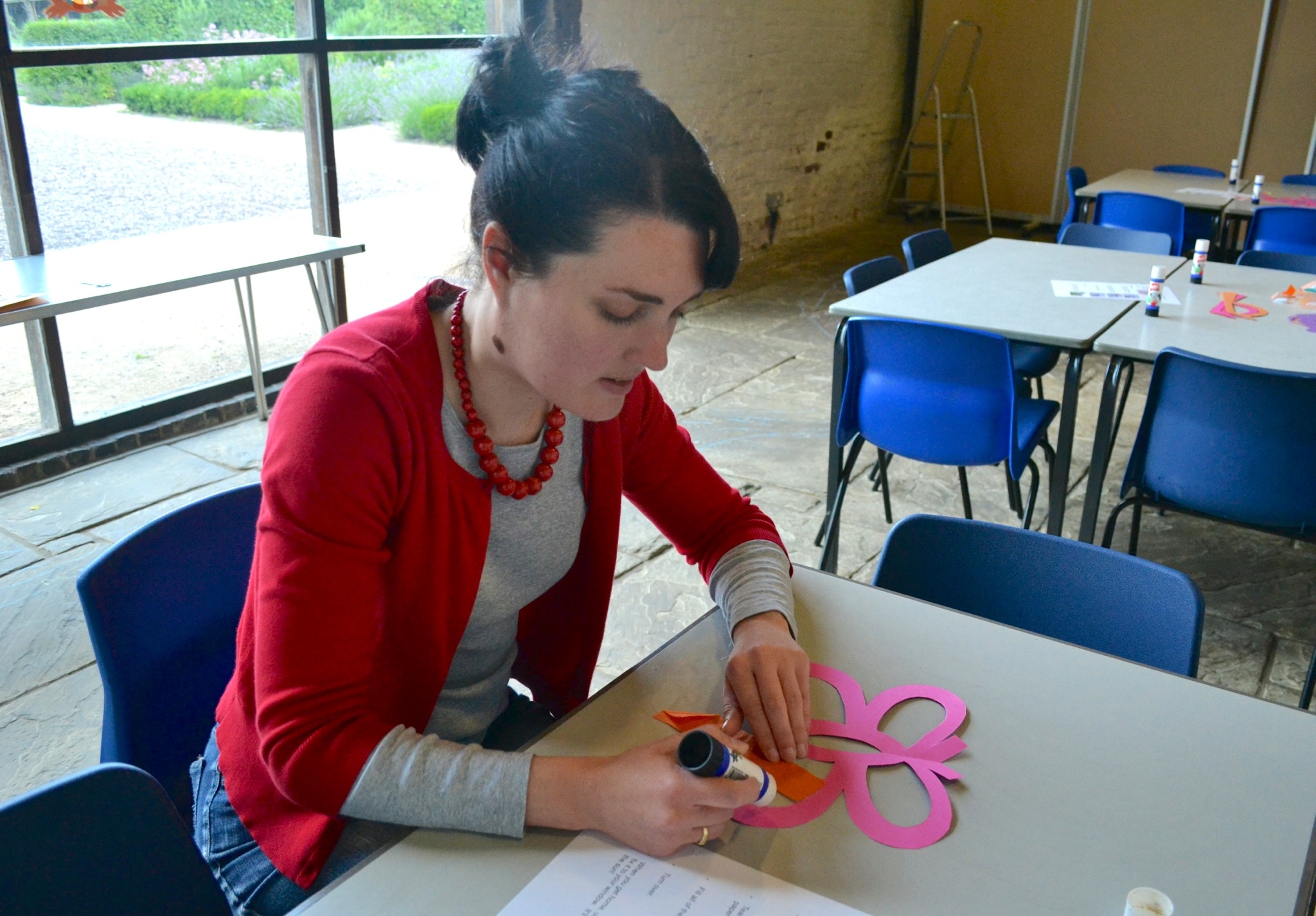 Participant engaged in creative activity at Blakesley Hall barn event.