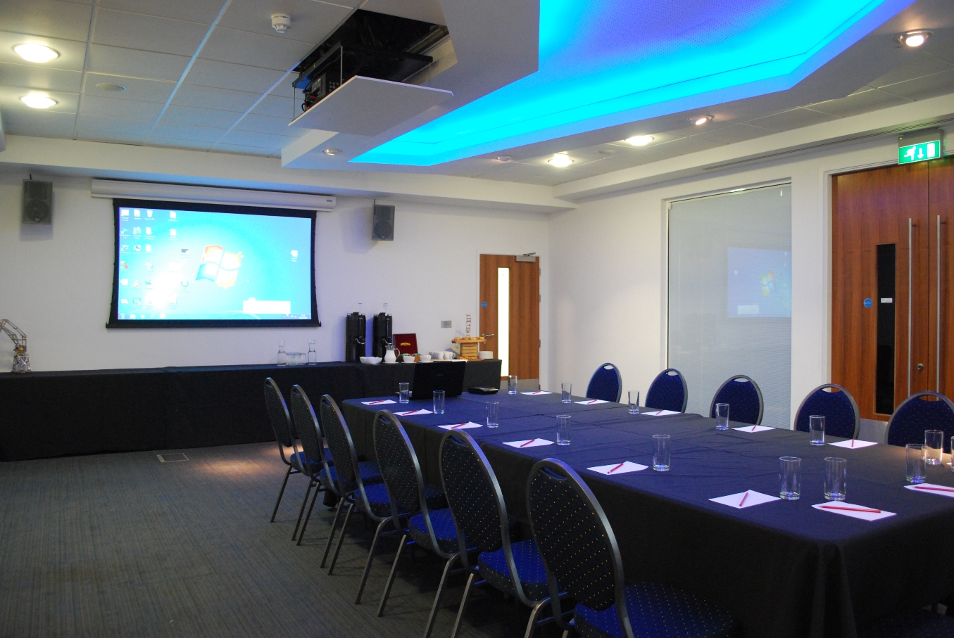 Events Suite in M Shed: modern meeting room with long table, ideal for conferences and presentations.