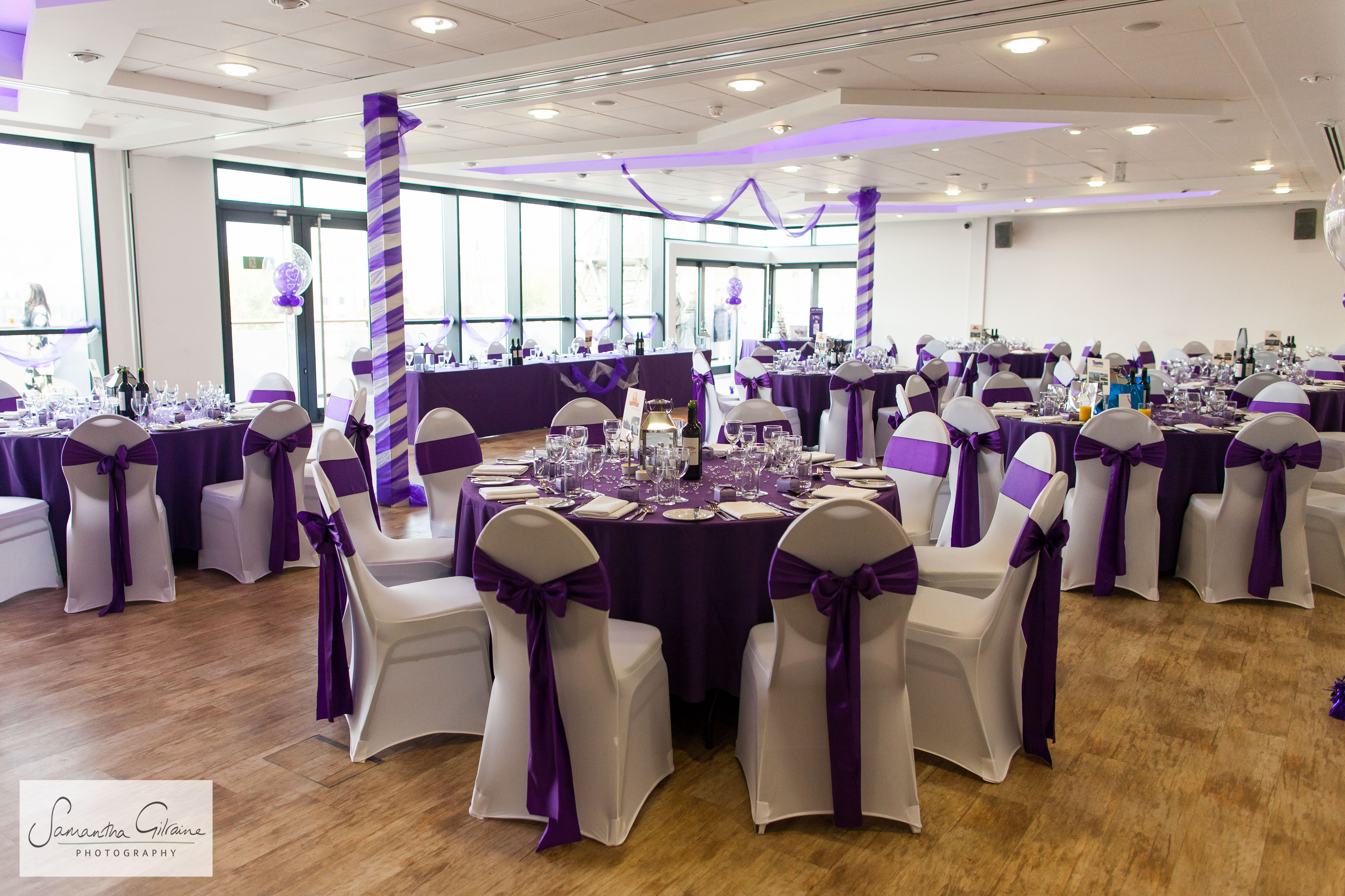 Elegant event space with purple decor, ideal for weddings and corporate events.