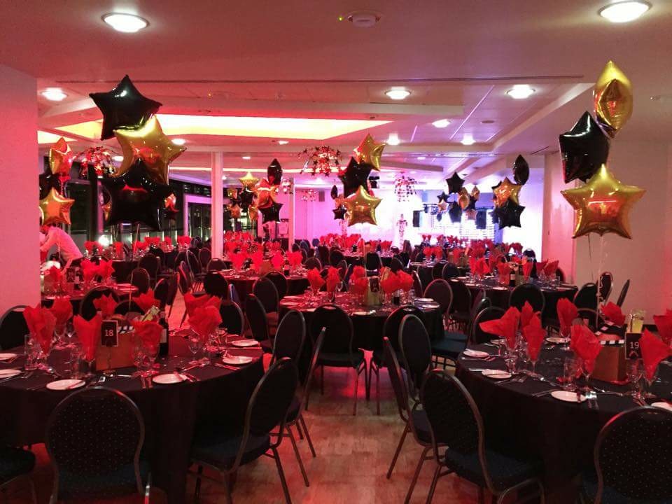 Elegant event space with black tablecloths, ideal for gala or formal dinner.