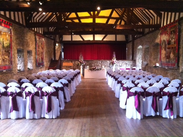 Elegant event space in Beaulieu with burgundy chairs, perfect for weddings and corporate events.