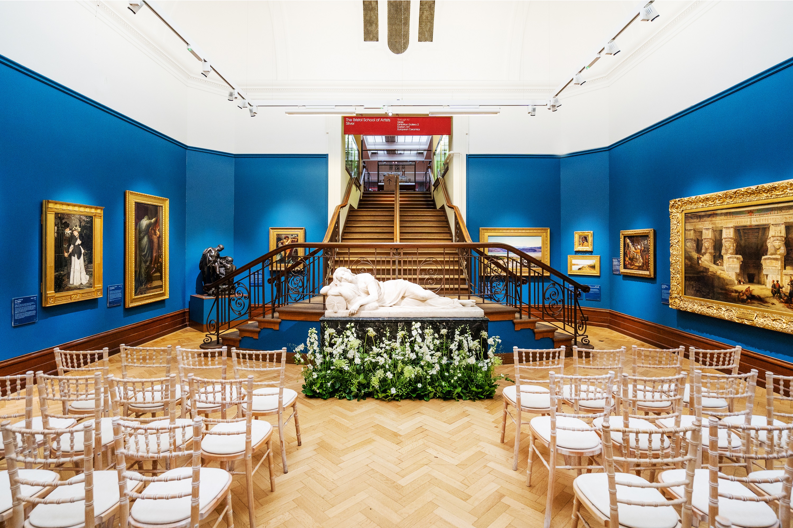 Elegant event space in Bristol Museum with blue walls, ideal for corporate meetings.
