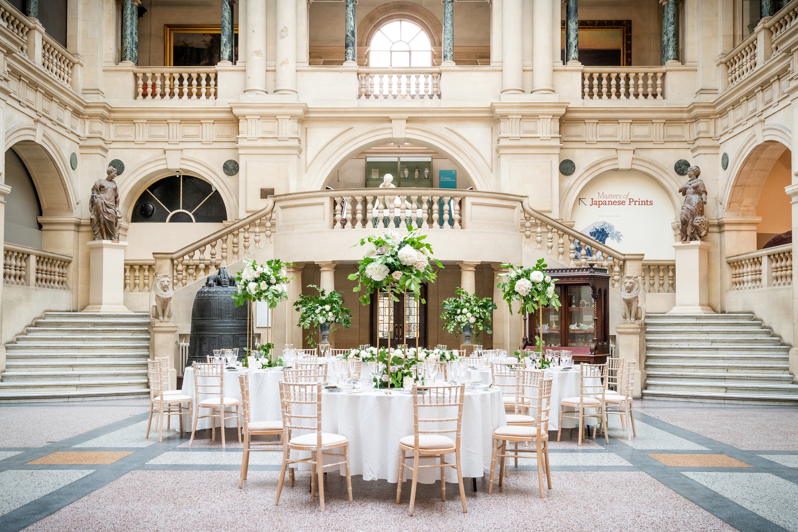 Elegant event space with grand staircase, ideal for weddings and upscale gatherings.