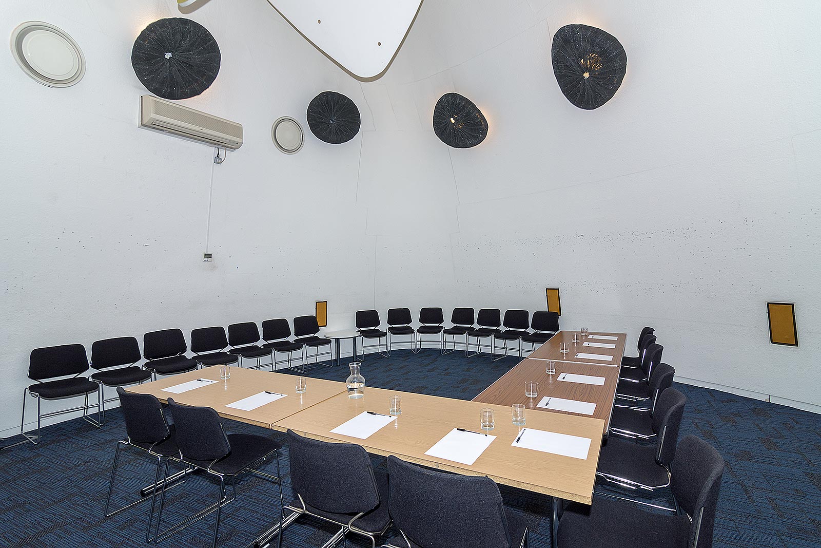 Modern meeting room in Peckham Library with circular seating for workshops and planning.