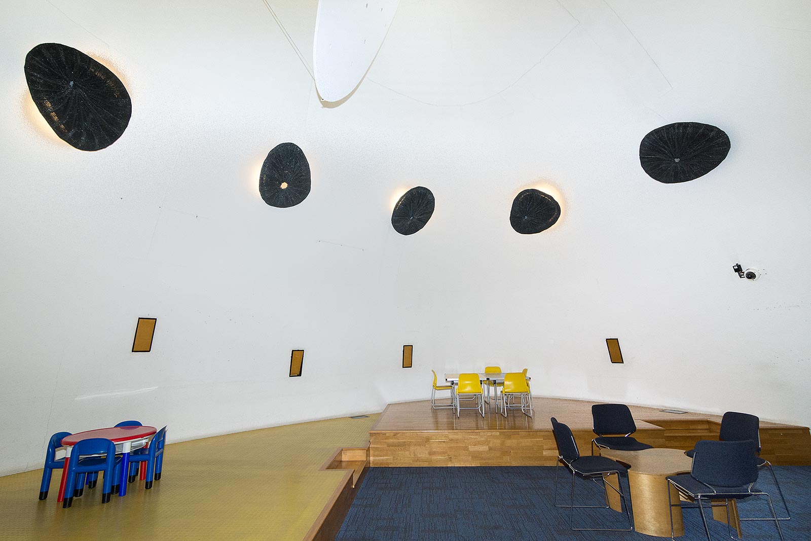 Modern event space in Peckham Library with a curved ceiling, ideal for workshops and meetings.