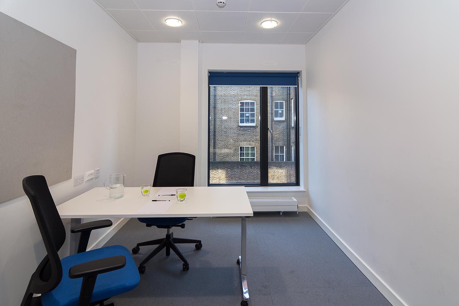 Minimalist meeting room with ergonomic chairs for productive discussions in Camberwell Library.
