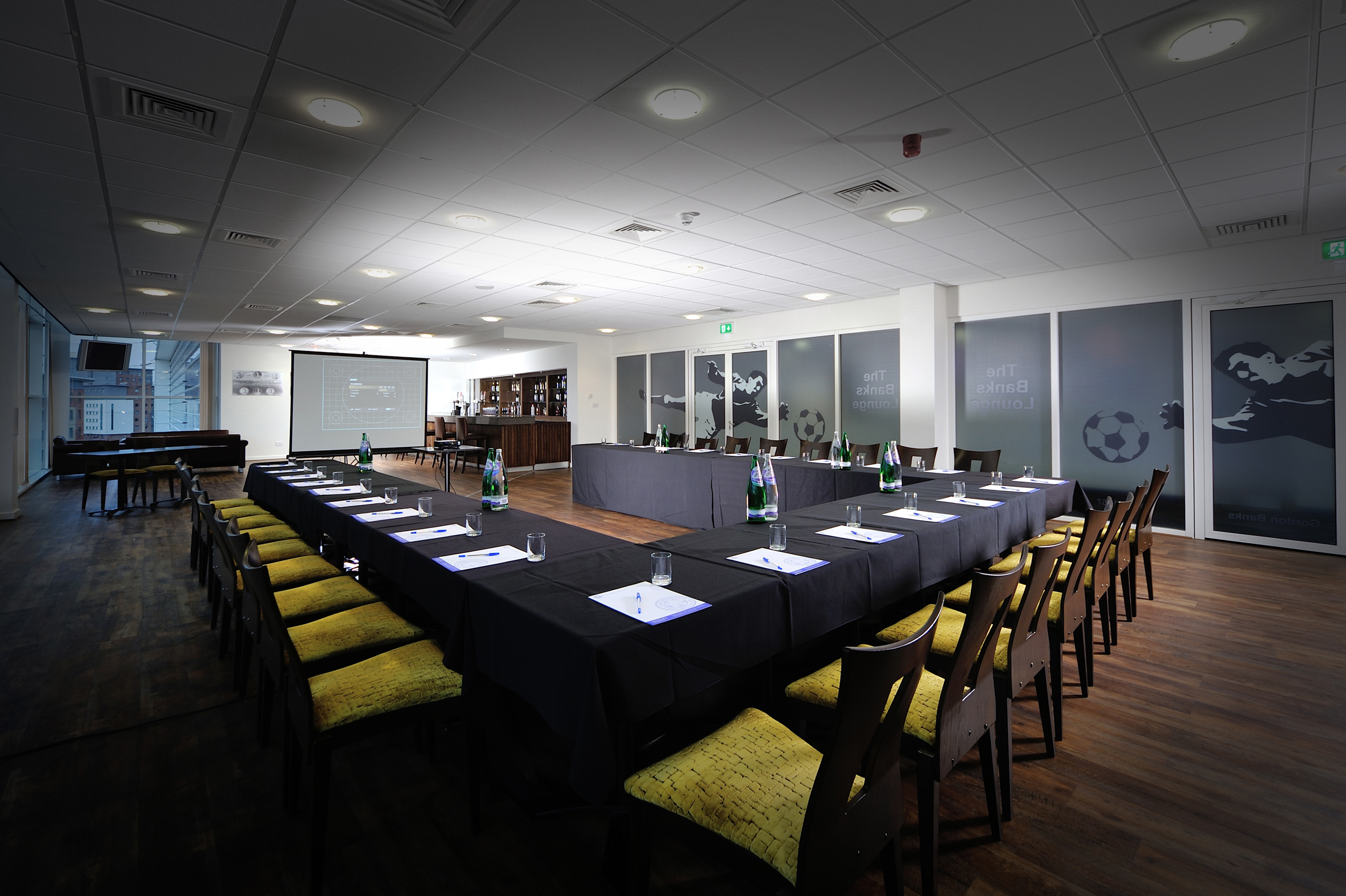 Banks Lounge at Leicester City FC: modern meeting room for corporate events with projector.