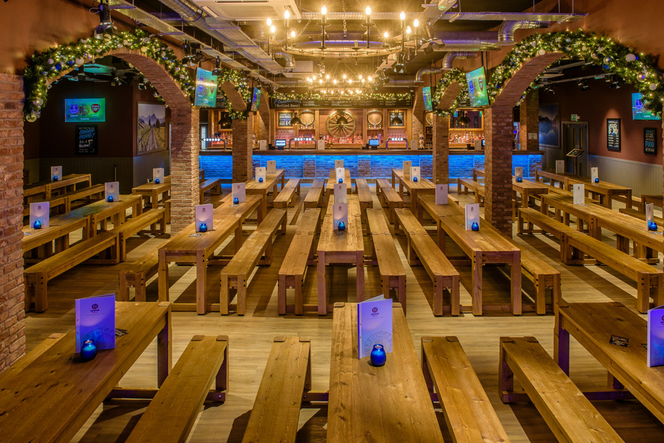 Bierkeller Bar venue with wooden benches, ideal for casual events and celebrations.