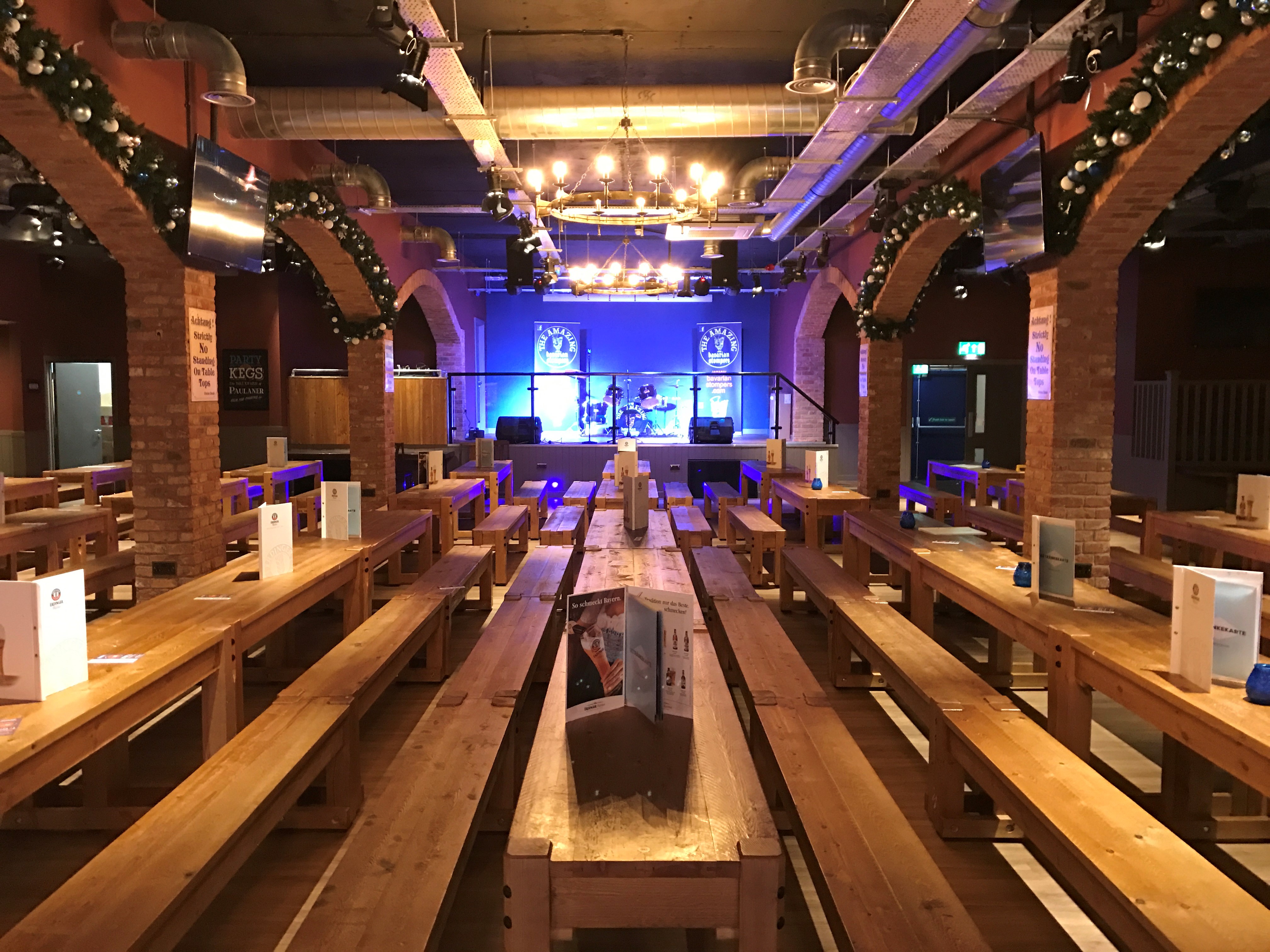 Bierkeller Bar event space with communal tables, ideal for networking and celebrations.