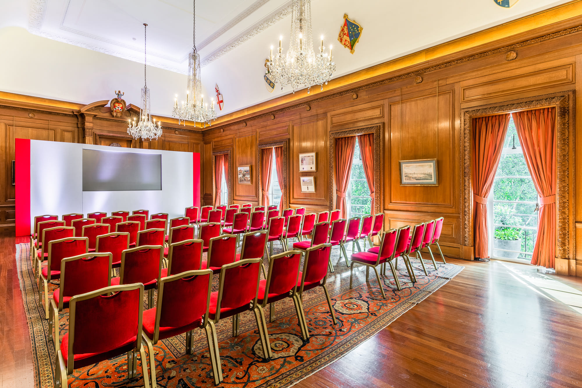 Elegant meeting room with wooden paneling, ideal for conferences and presentations.