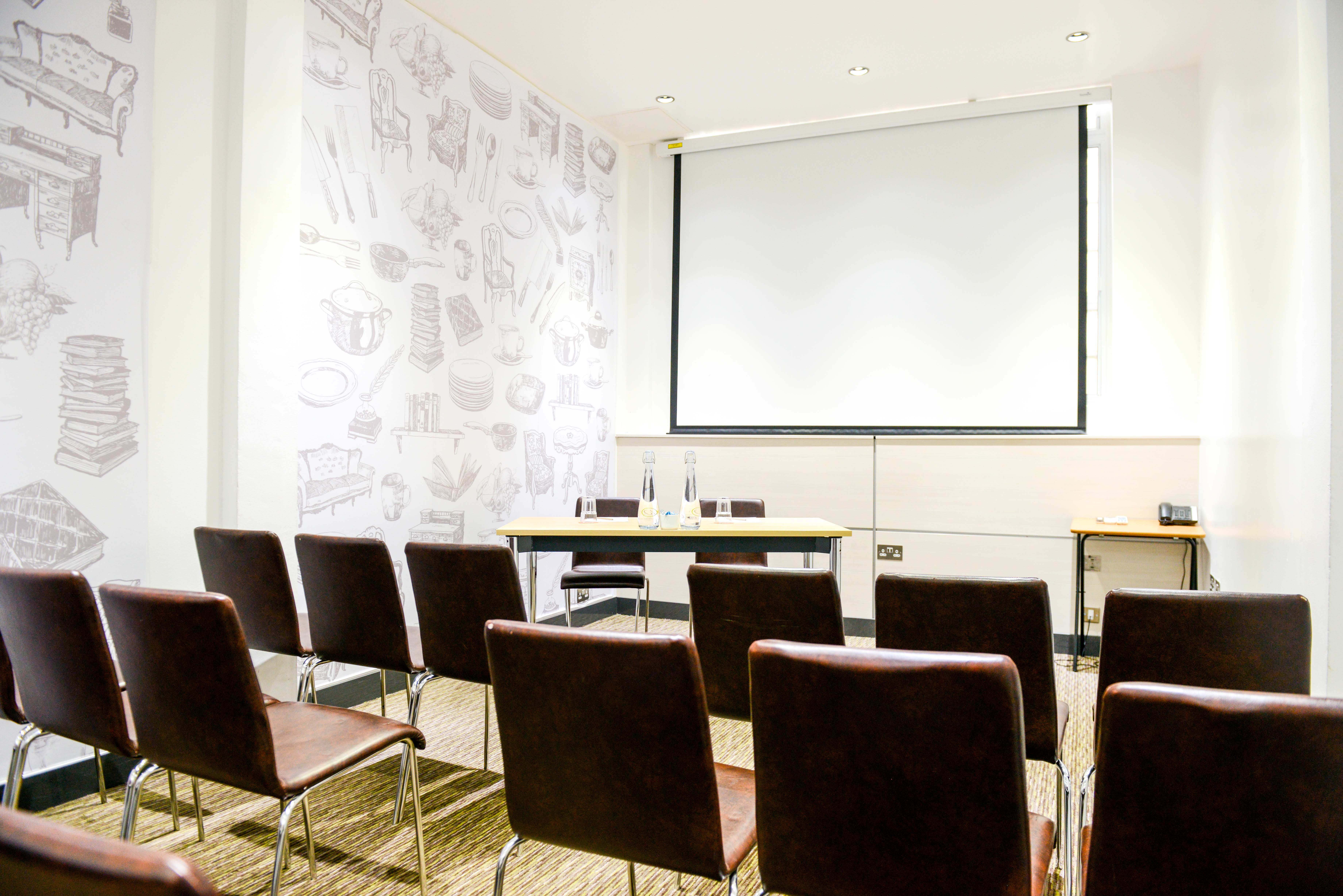 Meeting room in The Wesley Euston Hotel, featuring AV screen for conferences and presentations.