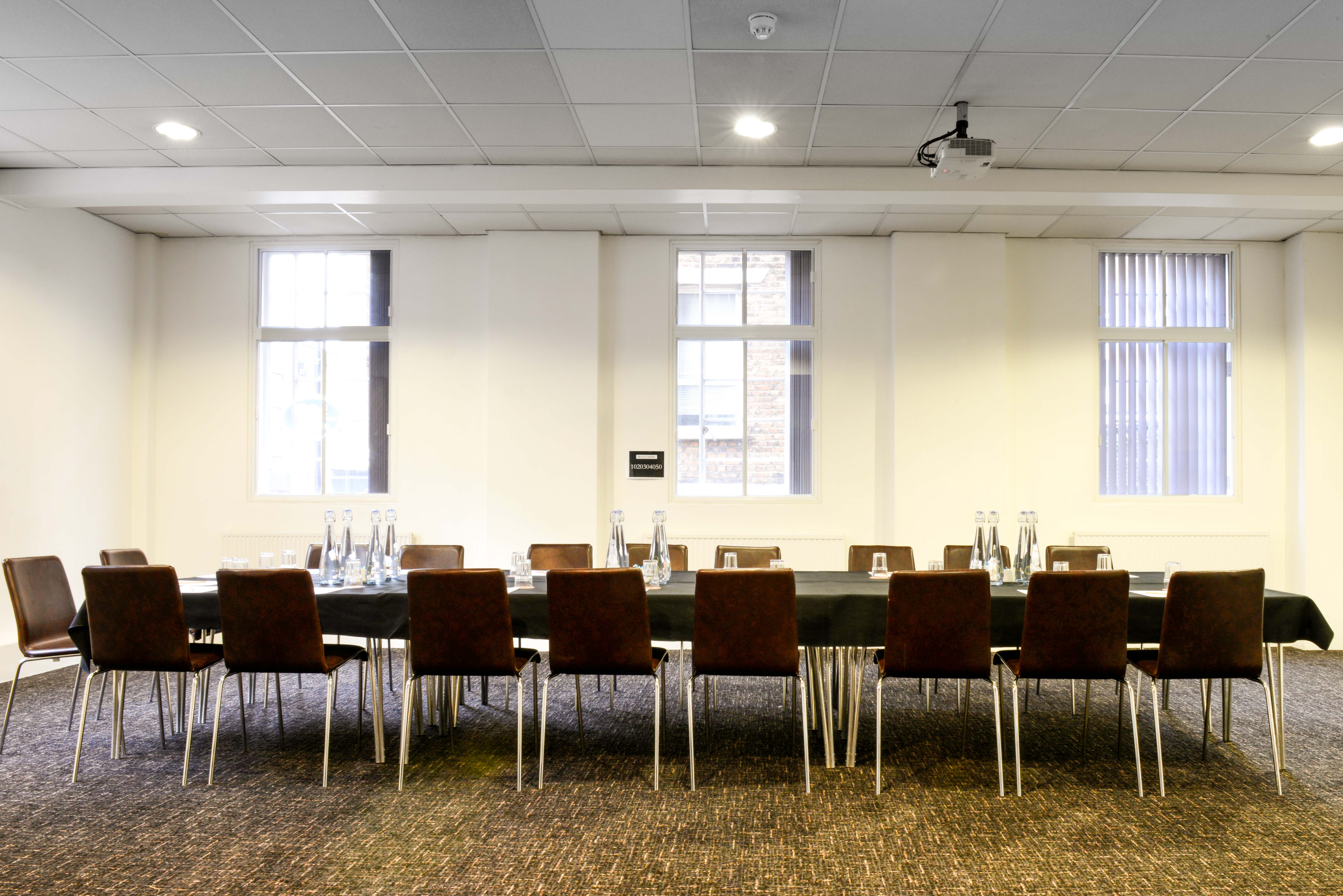 Meeting room at Wesley Euston Hotel, bright setup for professional gatherings and workshops.