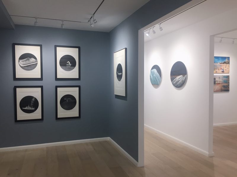 Modern event space in Arthill Gallery with framed art on a blue wall, ideal for gatherings.