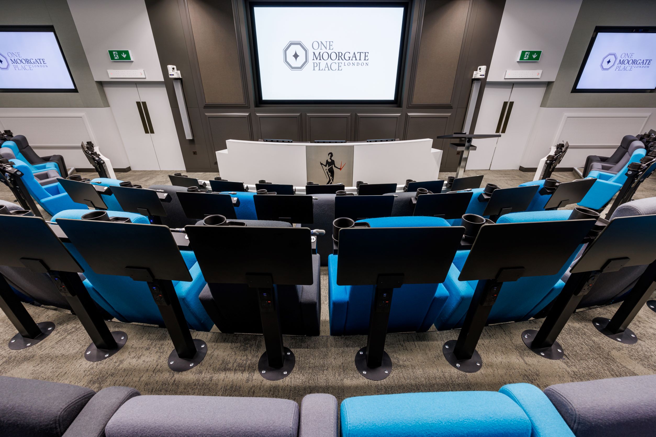 Modern conference room with tiered seating at One Moorgate Place for corporate events.