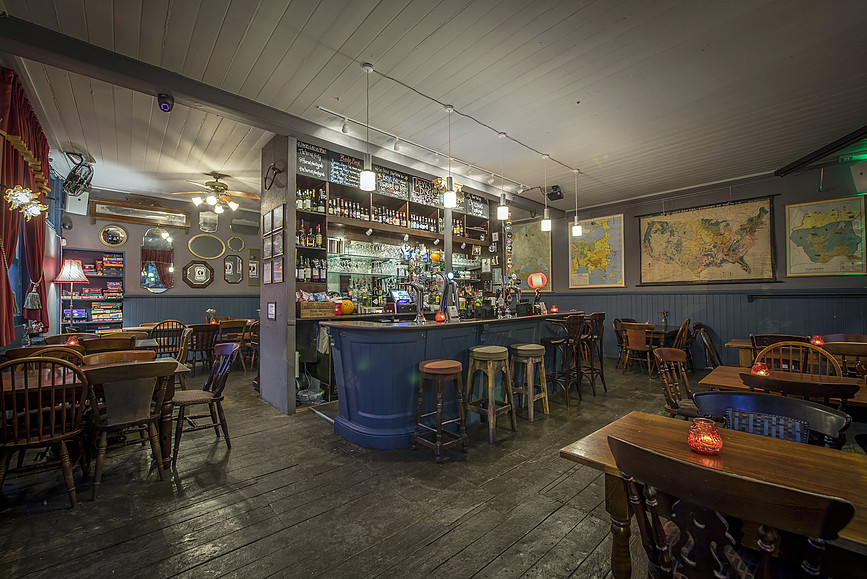 Cozy Whole Pub venue with warm lighting, ideal for intimate gatherings and networking events.