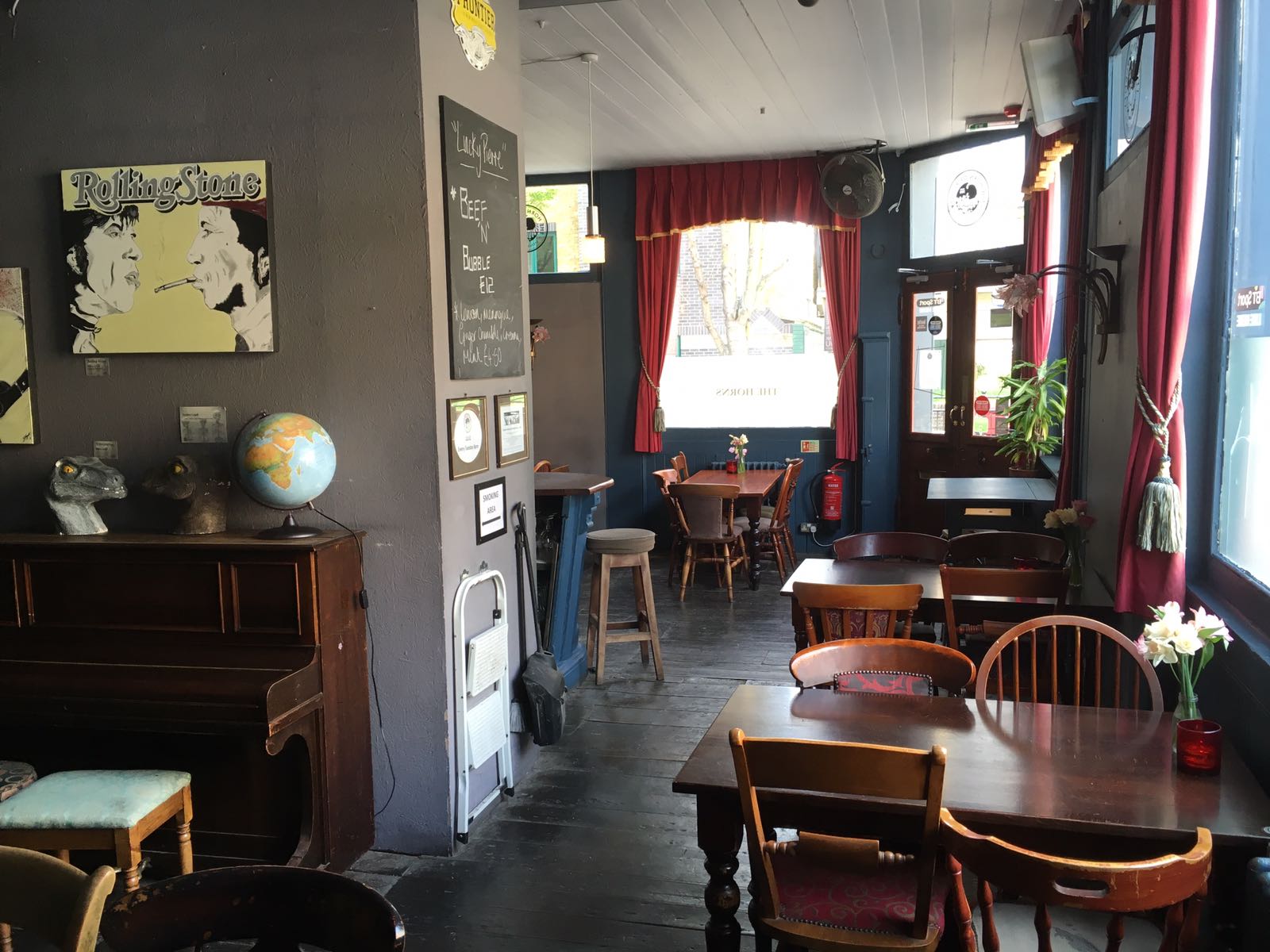 Cozy Whole Pub venue with wooden tables, ideal for casual gatherings and meetings.