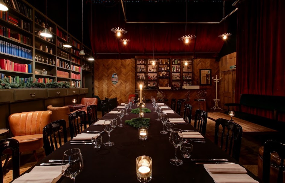 Elegant dining room with candlelit table for intimate gatherings and corporate events.