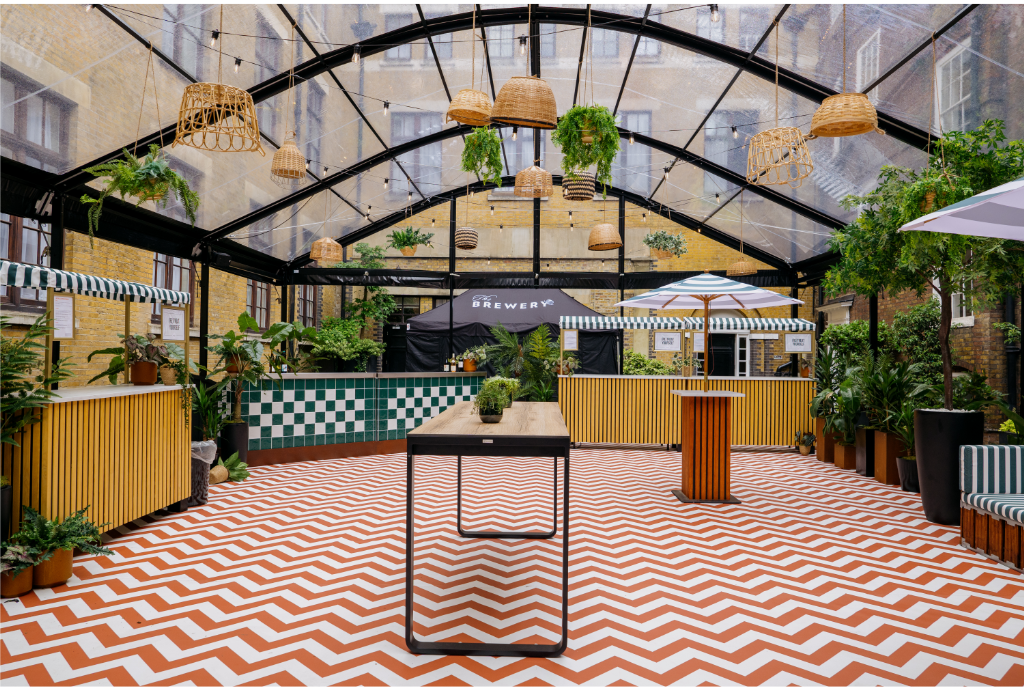 Vibrant summer party at The Retreat in The Brewery with greenery and chevron flooring.