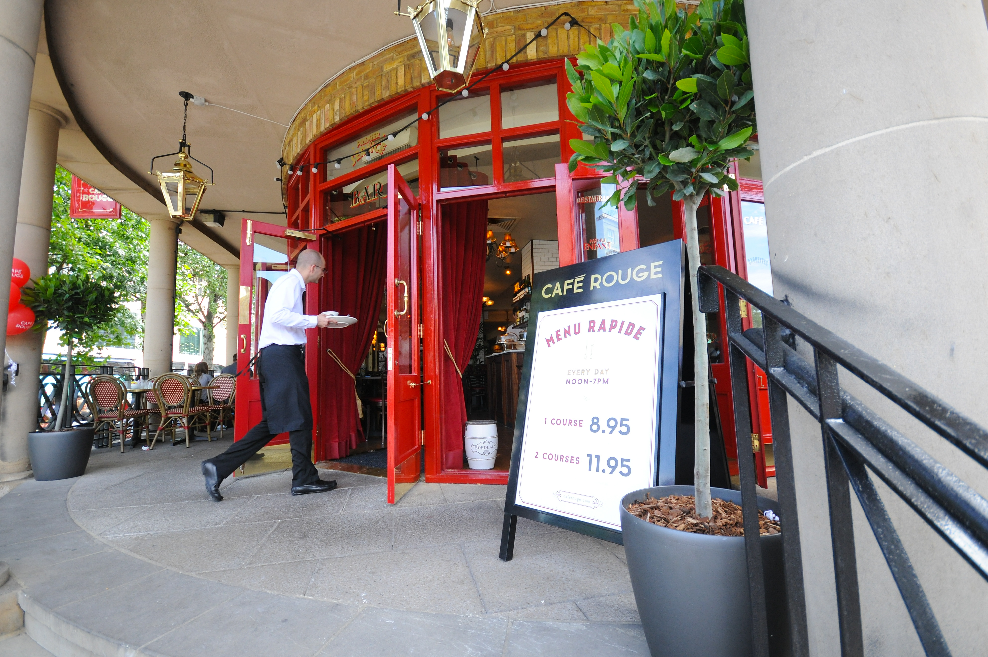 Café Rouge Greenwich entrance with red doors, perfect for casual meetings and networking events.