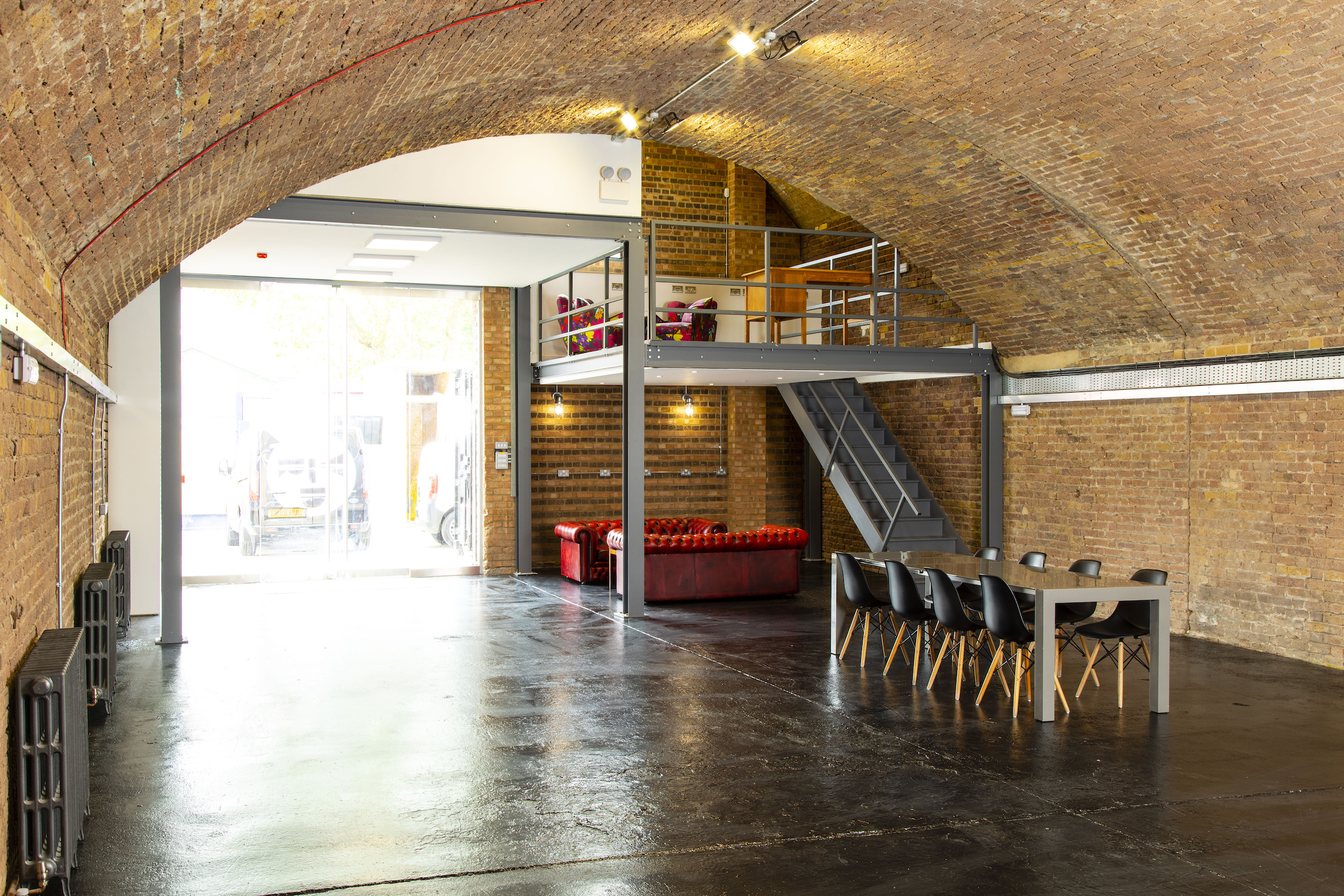 Versatile event space in Rida Haggerston with exposed brick walls and high ceilings.