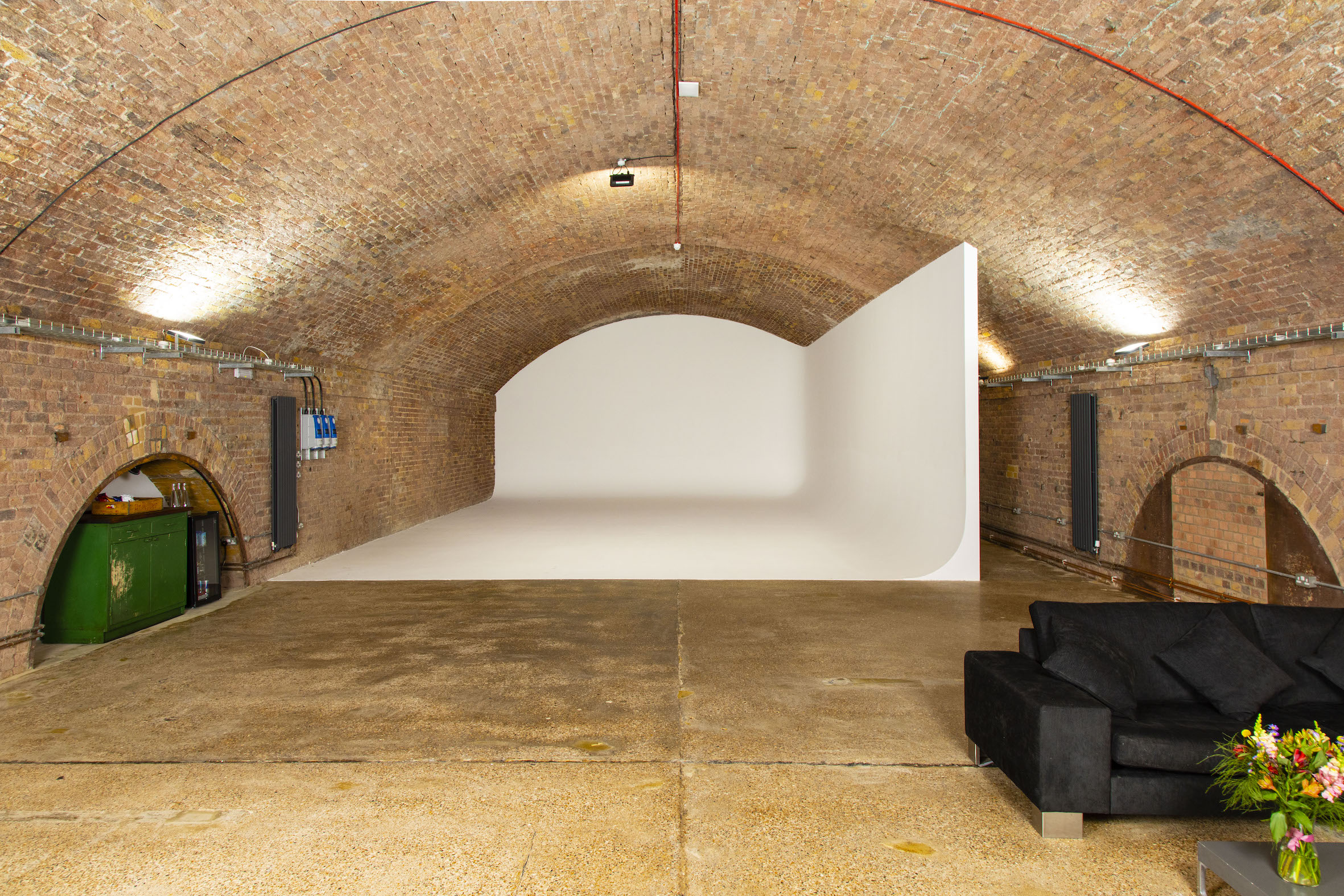 Versatile event space in Rida Haggerston with arched brick ceiling, ideal for corporate events.