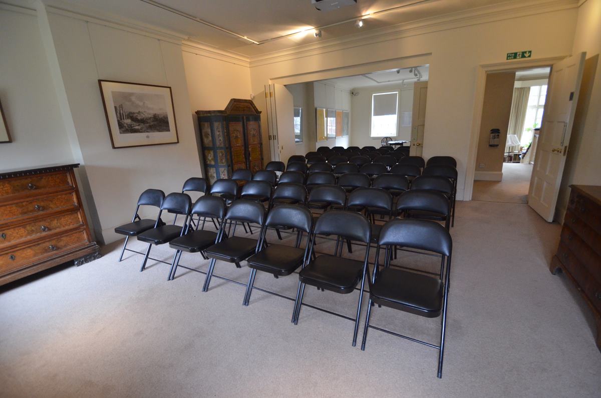 Video Room in Freud Museum London with black folding chairs for events and presentations.