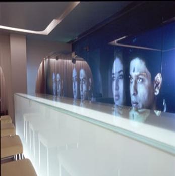Sleek Club Bar at Cinnamon Club with digital display, ideal for upscale events and networking.