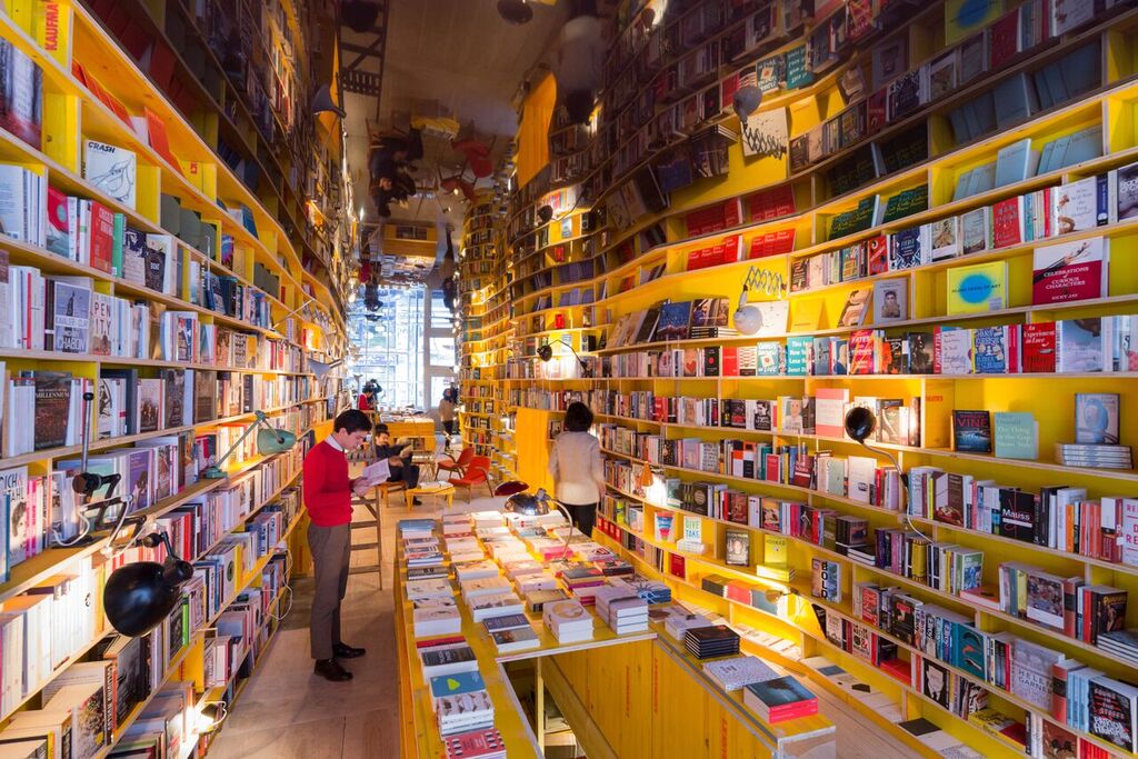 Vibrant modern bookstore with yellow shelves, perfect for book launches and events.
