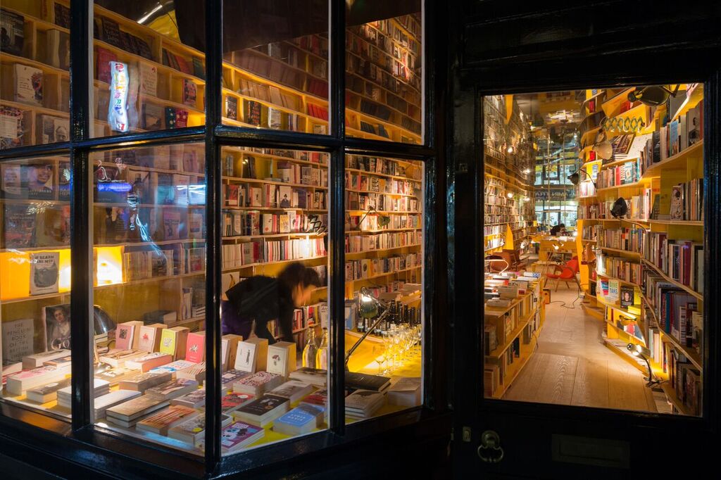 Cozy bookstore with warm lighting, ideal for literary events and book launches.