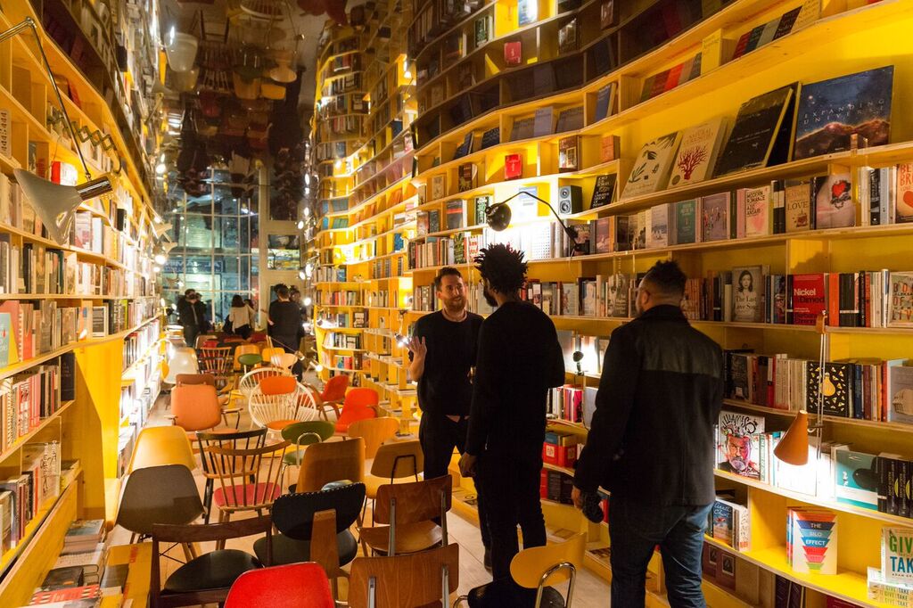 Vibrant bookshop venue with unique shelving for creative meetings and events.