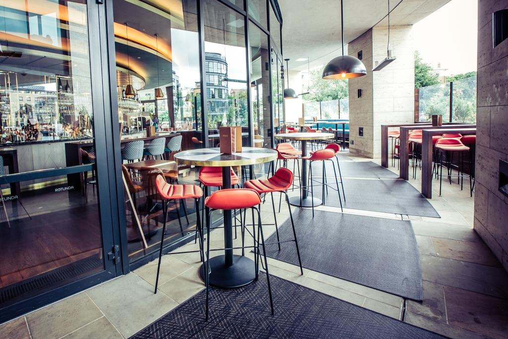 Modern Rotunda Bar venue with vibrant seating, perfect for networking events.
