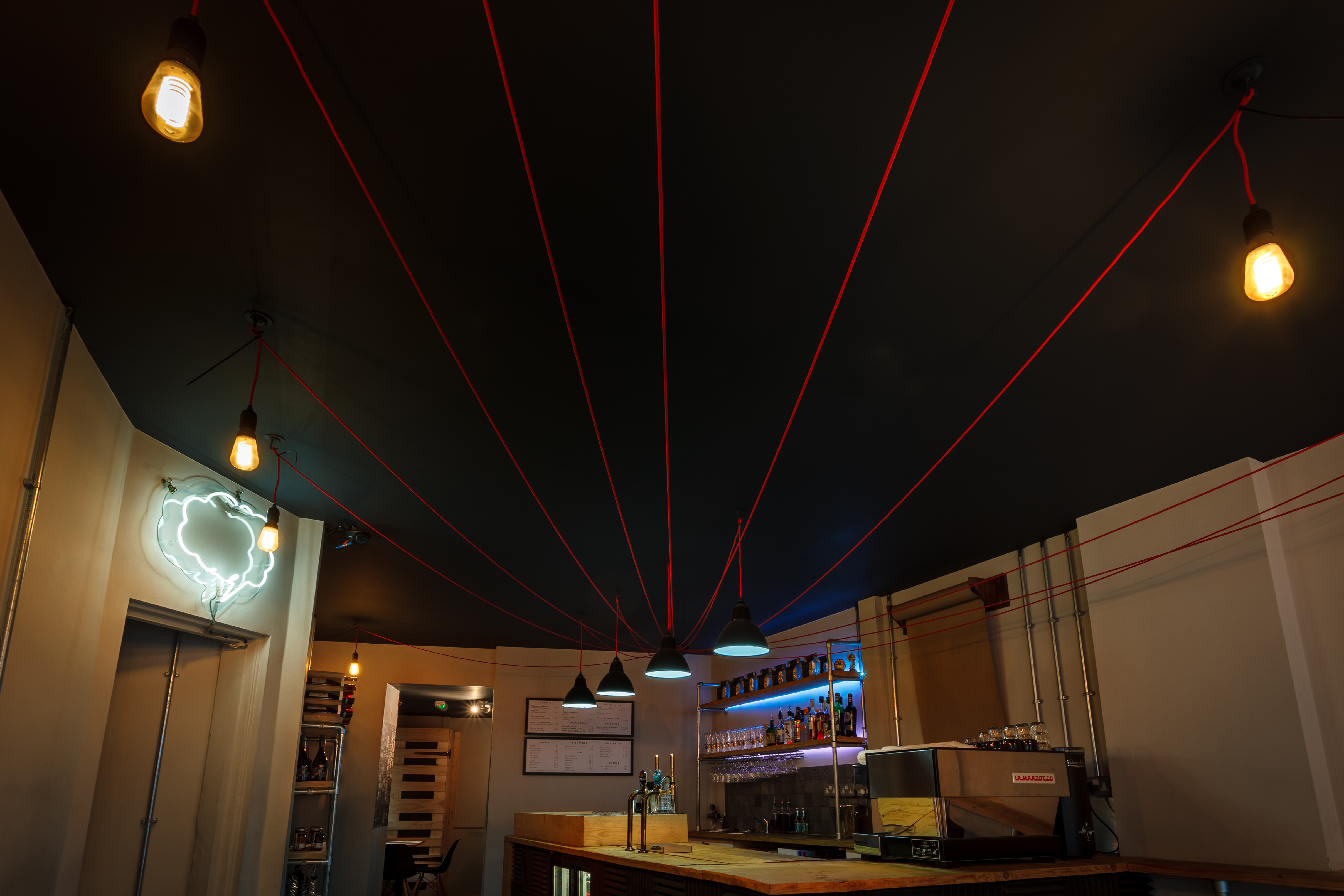 Modern event space with industrial design, ideal for casual meetings and networking.