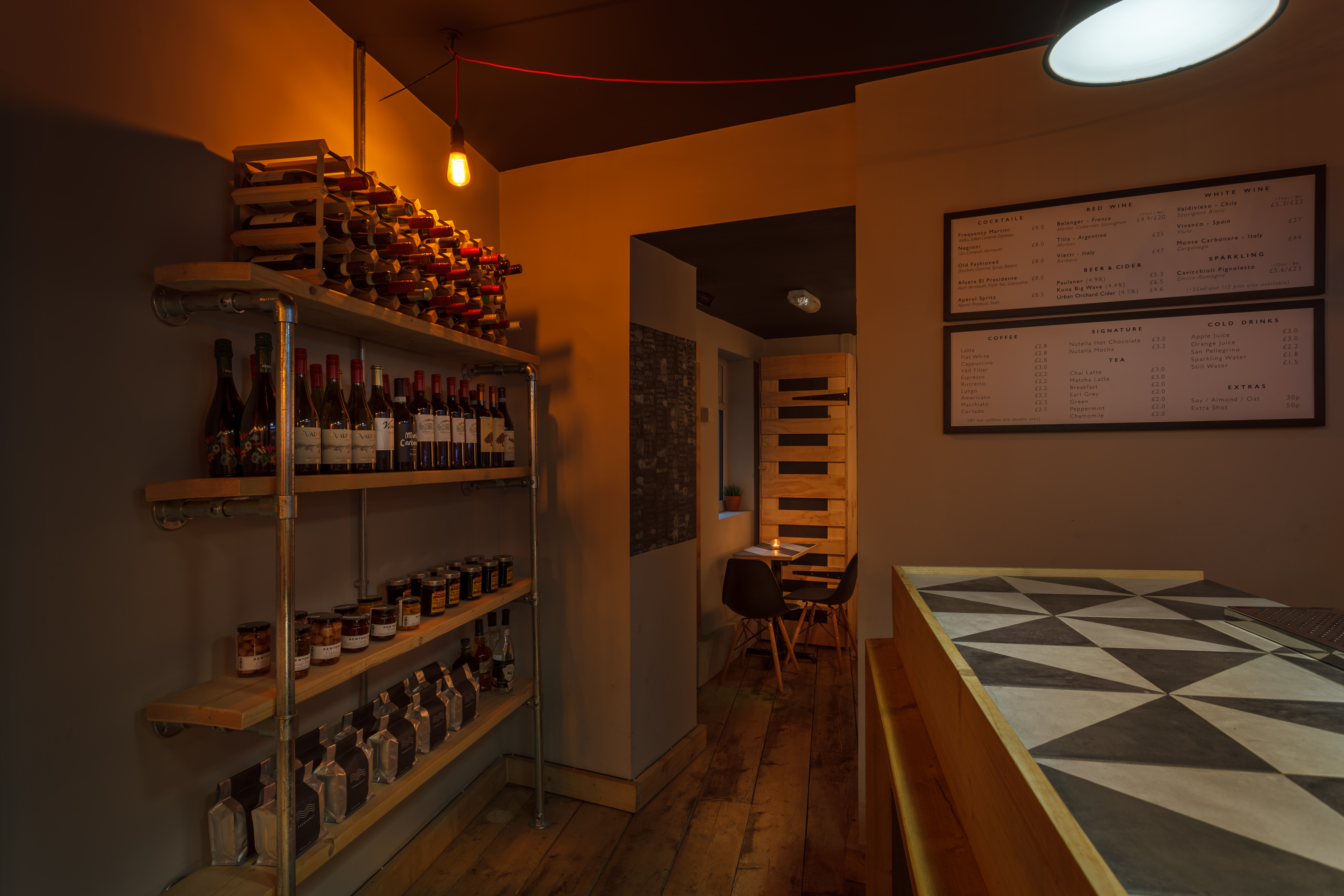 Cozy cafe and bar with warm lighting, ideal for private events and gatherings.