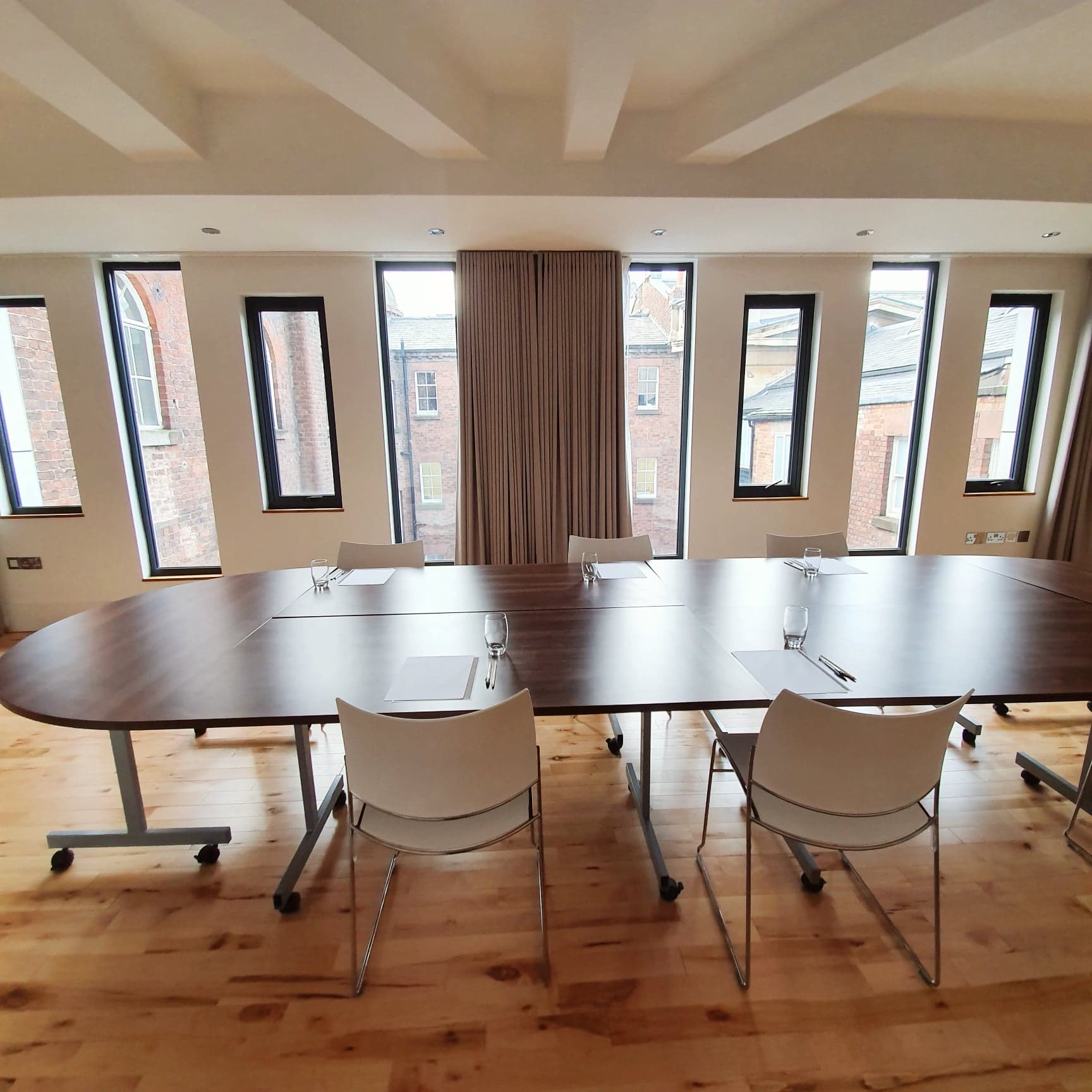 Modern meeting room at Hope Street Hotel with oval table for workshops and collaboration.