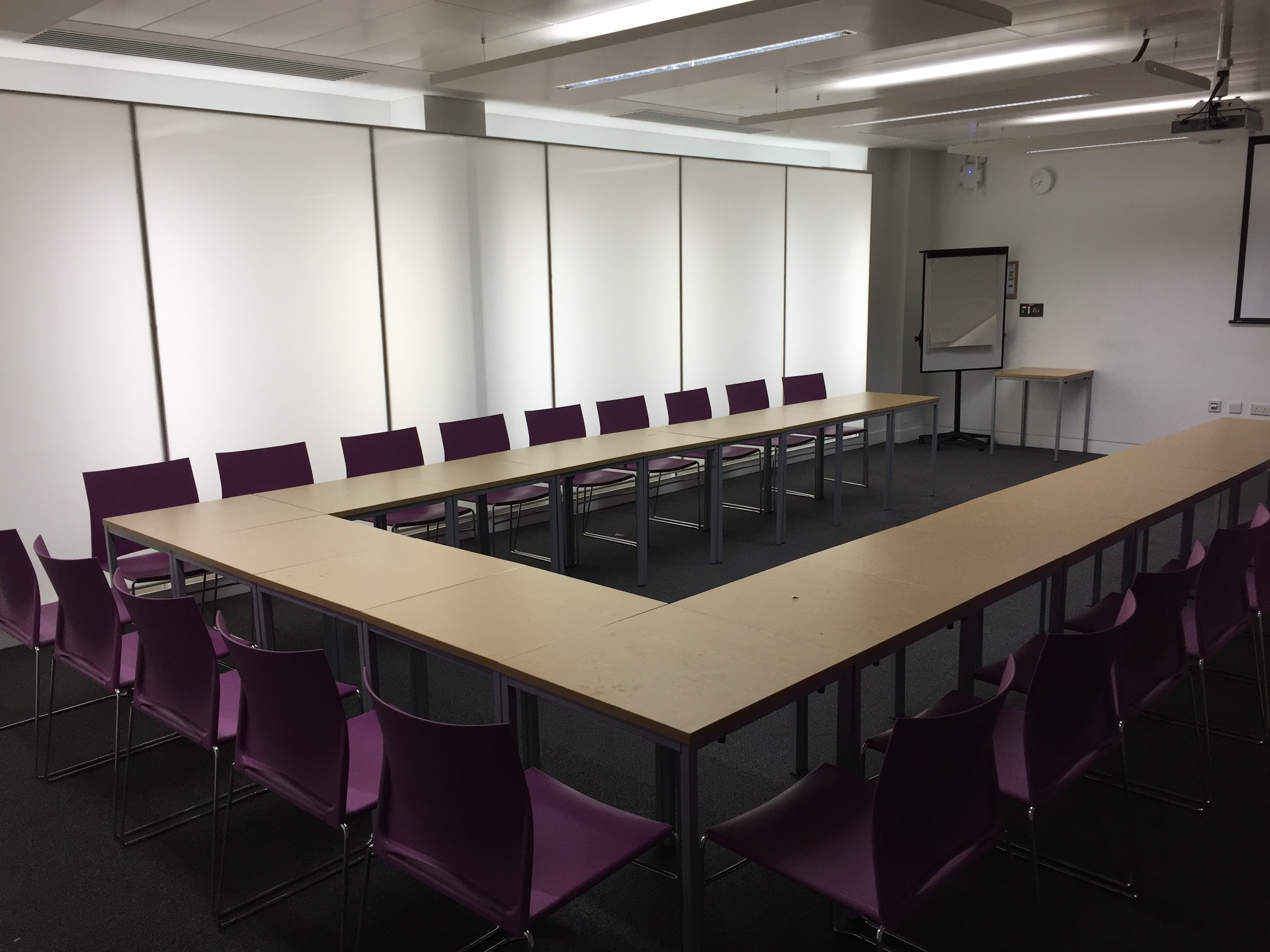 Blomeley Room 1 at Queen Mary University, U-shaped meeting room with purple chairs.