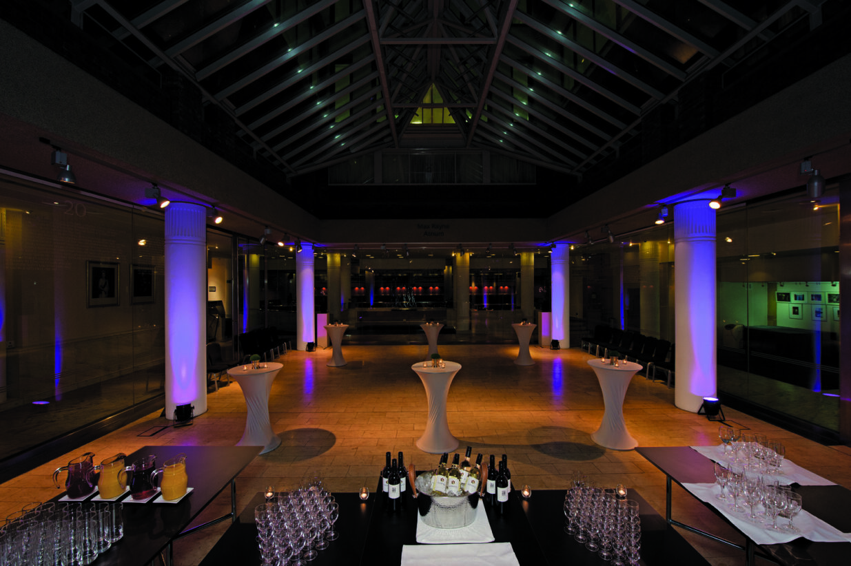 Max Rayne Atrium event space with elegant cocktail tables, ideal for receptions and networking.