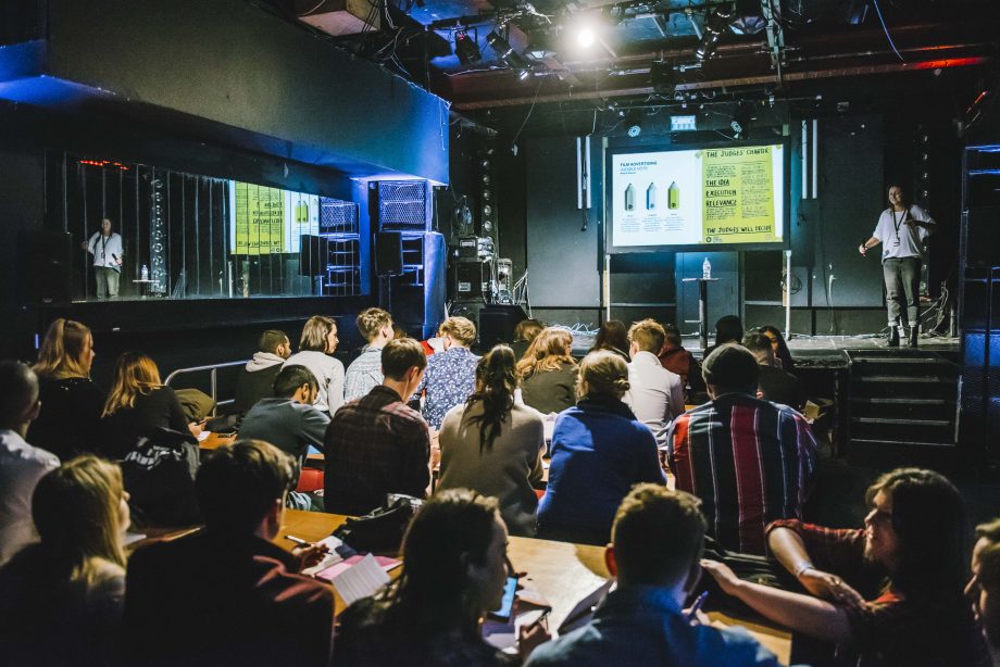 Engaged audience at Electrowerkz live event with modern stage lighting and seating.