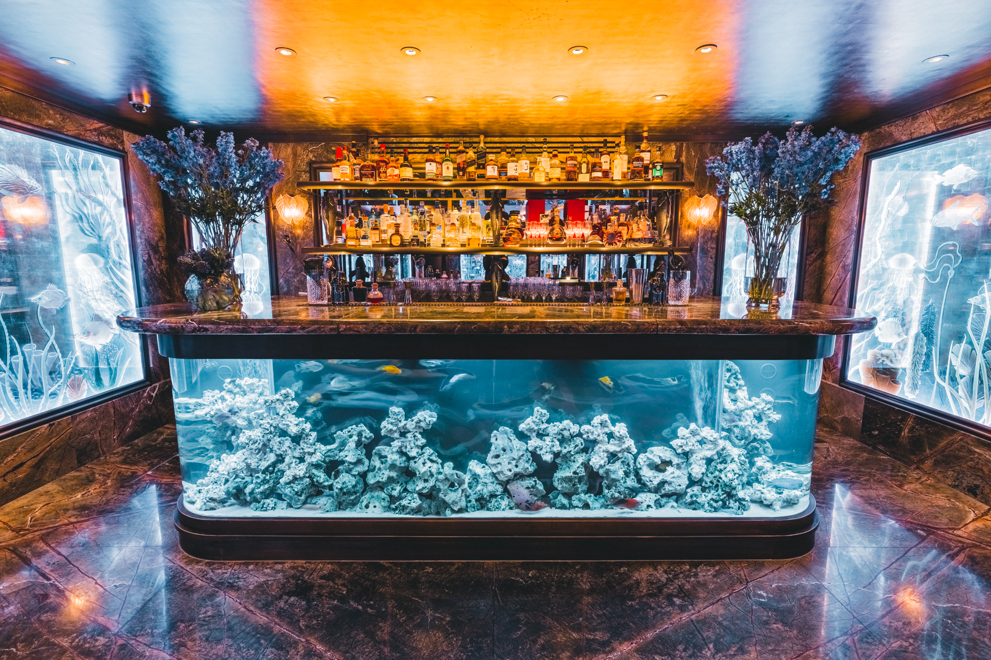 Elegant bar with aquarium backdrop for cocktail receptions and intimate gatherings.