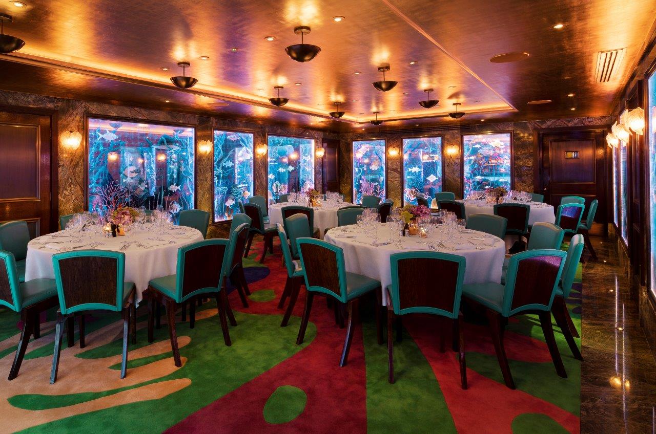 Sophisticated dining space with teal chairs for upscale events at Scott's Private Room.
